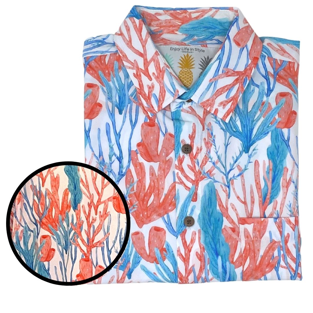 Folded shirt with coral and pineapple pattern on a white background