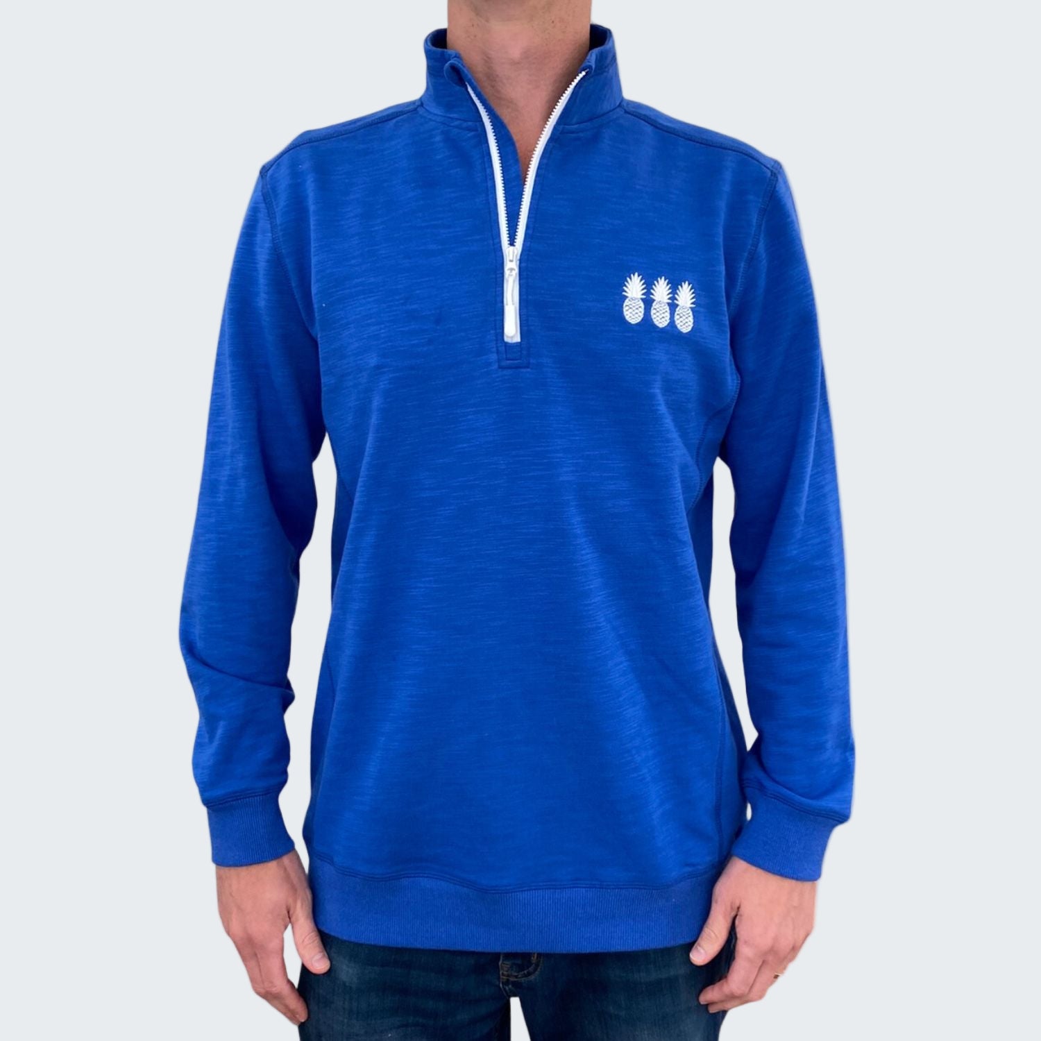 Blue pullover with a white zipper and logo on a white background