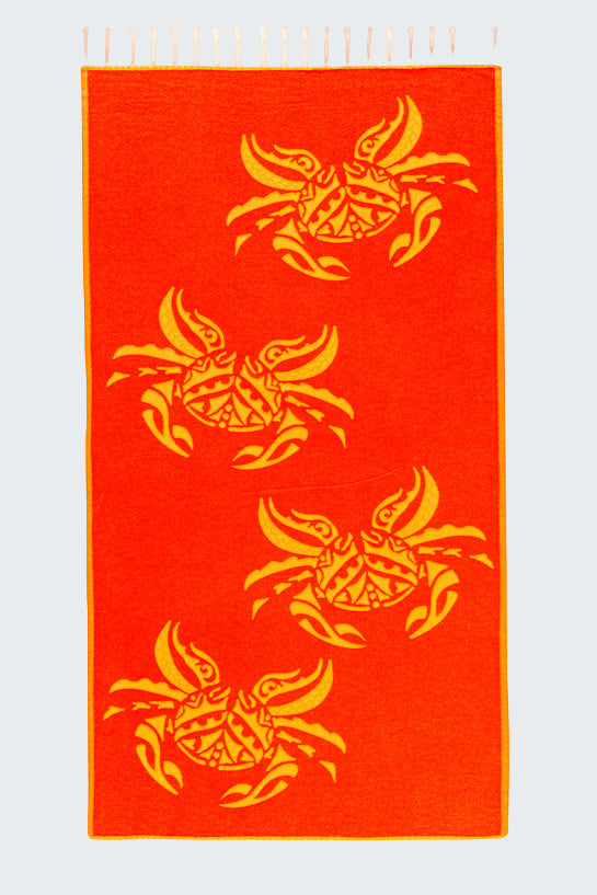 Red towel with yellow fish patterns on a white background
