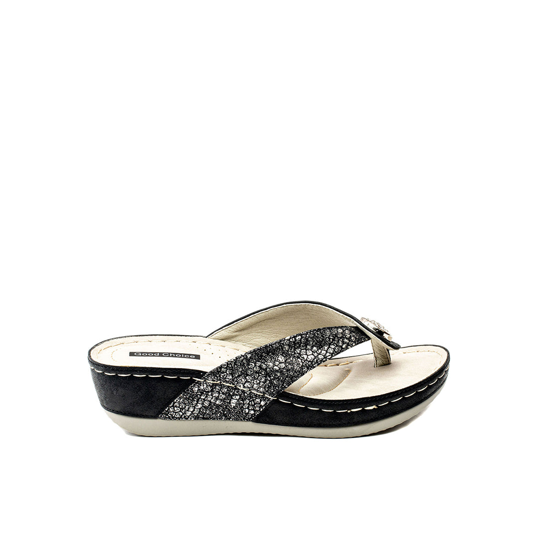 Black and white sandal with criss-cross strap design on a white background