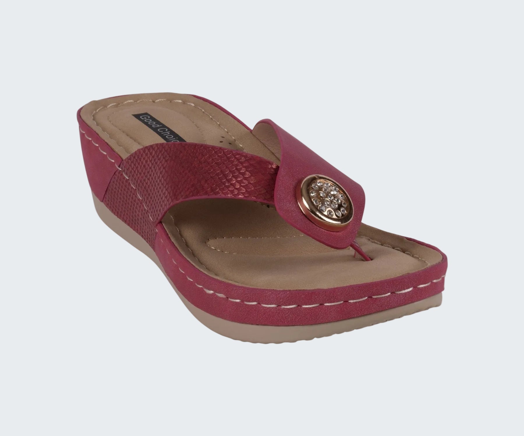 Red sandal with a decorative button on a white background