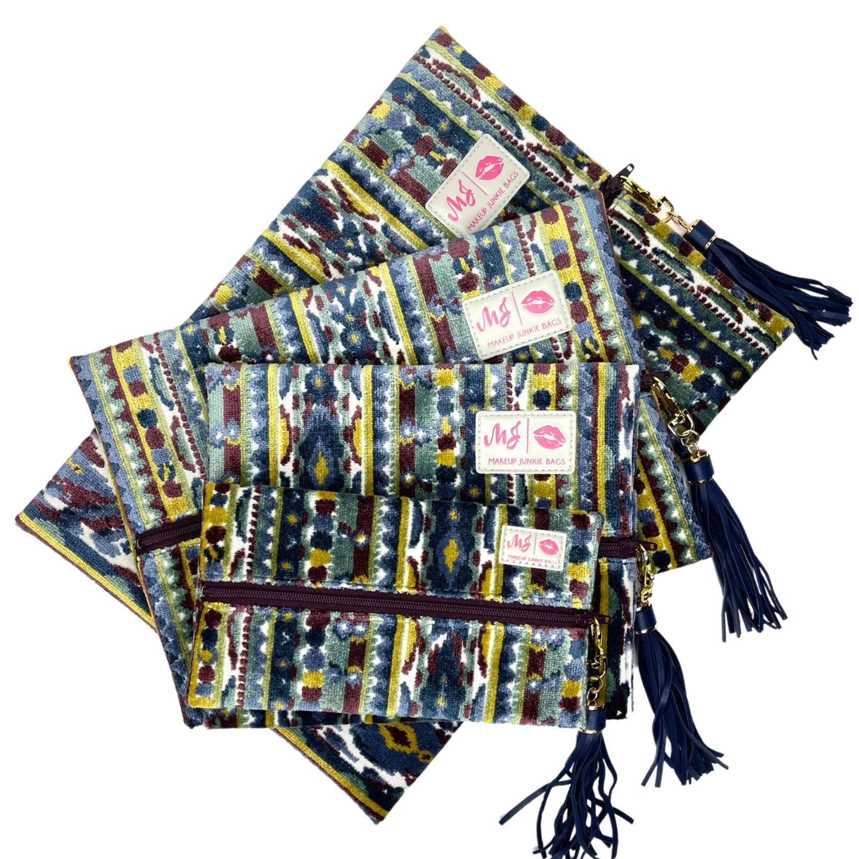 Colorful patterned pouches with tassels and visible brand label on a white background