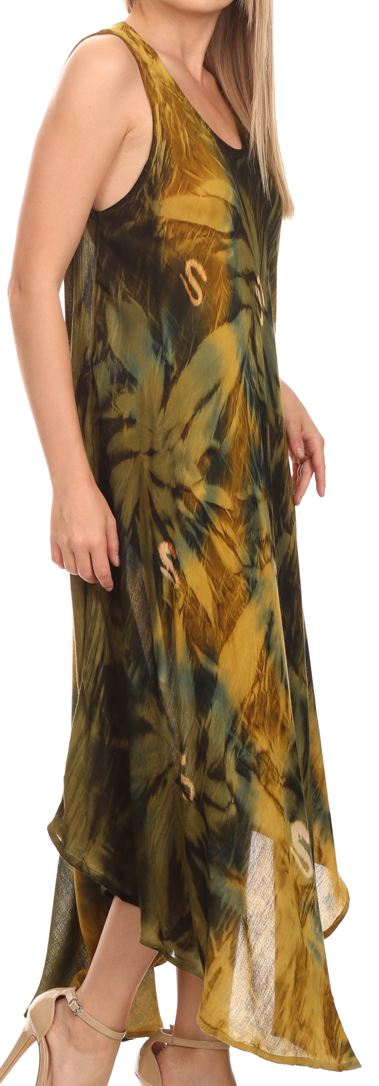 Woman wearing a sleeveless, tie-dye dress with a pattern of green, yellow, and brown on a white background.