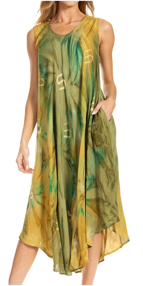 Woman wearing a sleeveless dress with green and yellow leaf pattern on a white background