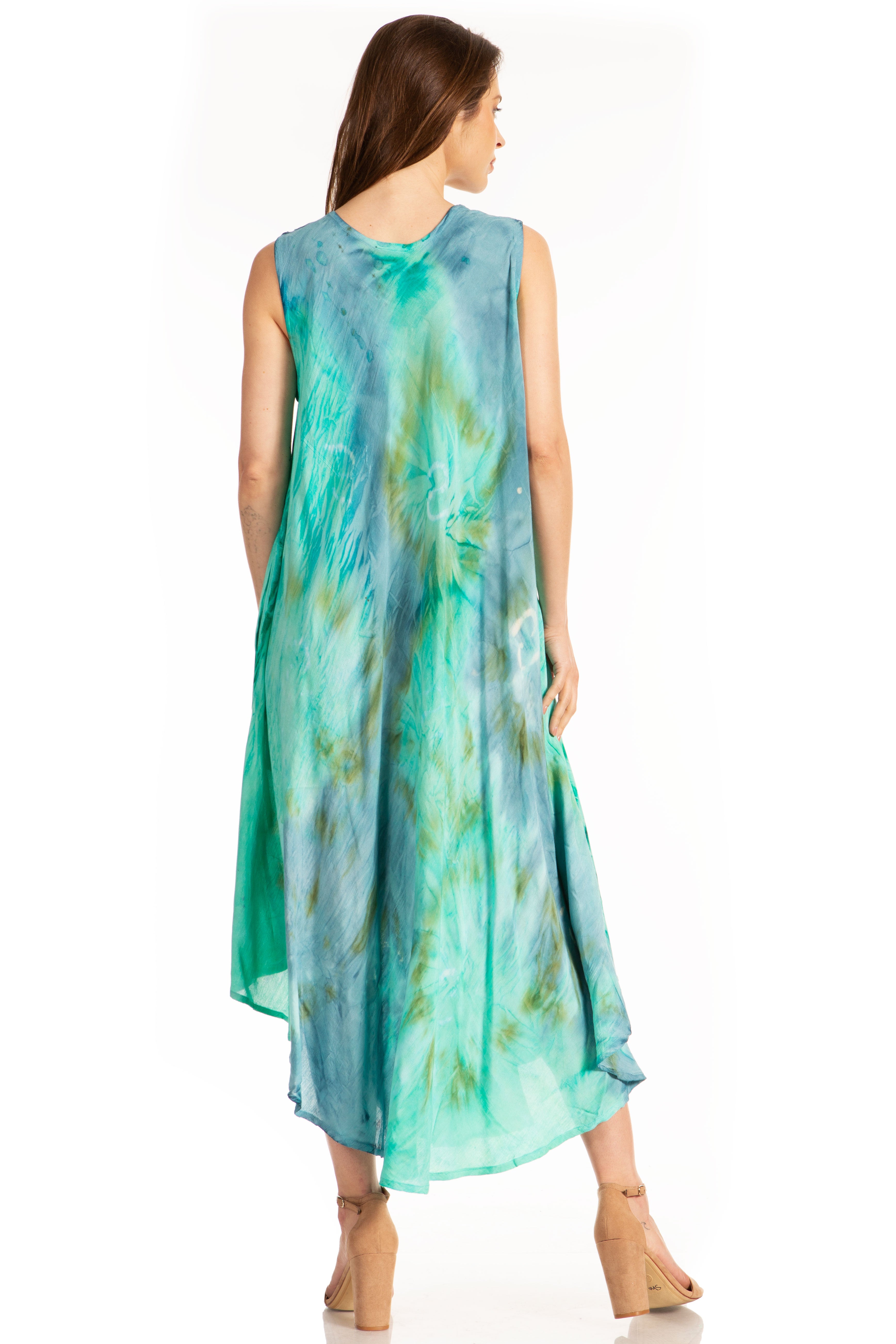 Woman wearing a sleeveless, teal and green tie-dye dress on a white background