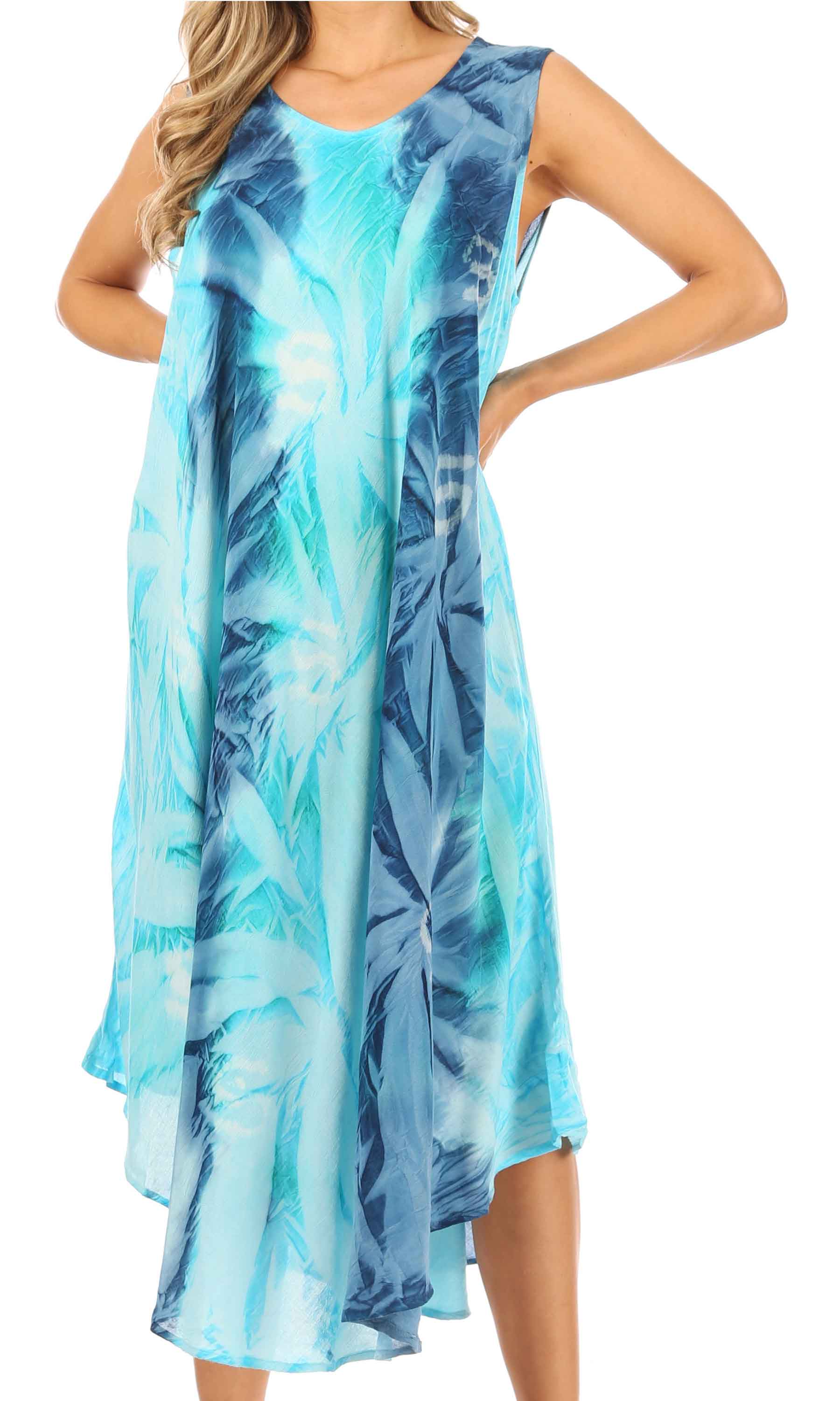 Woman wearing a blue and green leaf-patterned dress on a white background