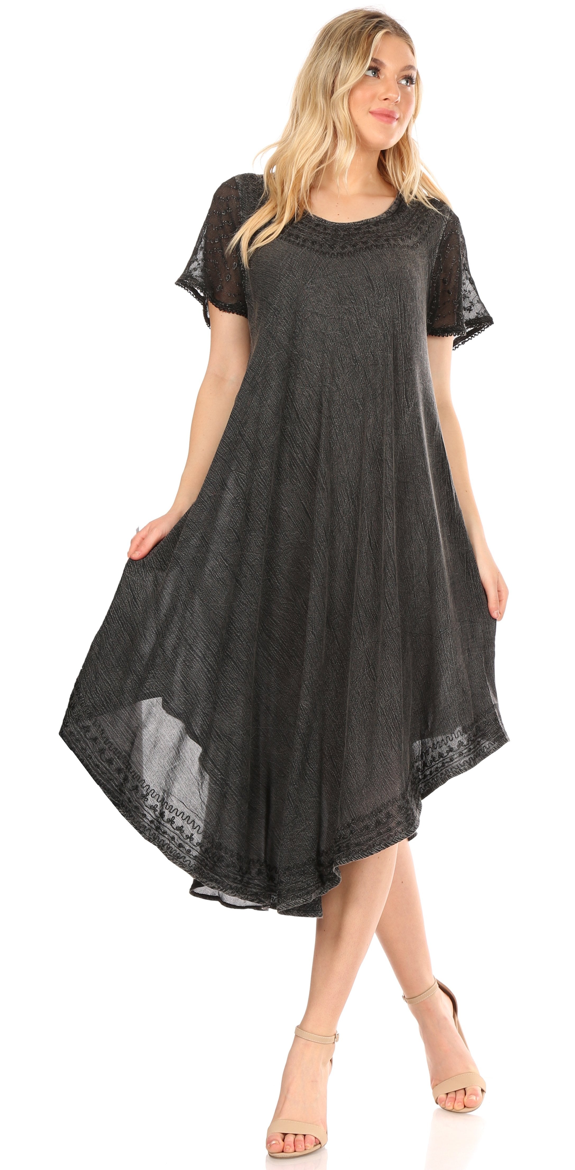 Woman wearing a black dress with lace details on a white background