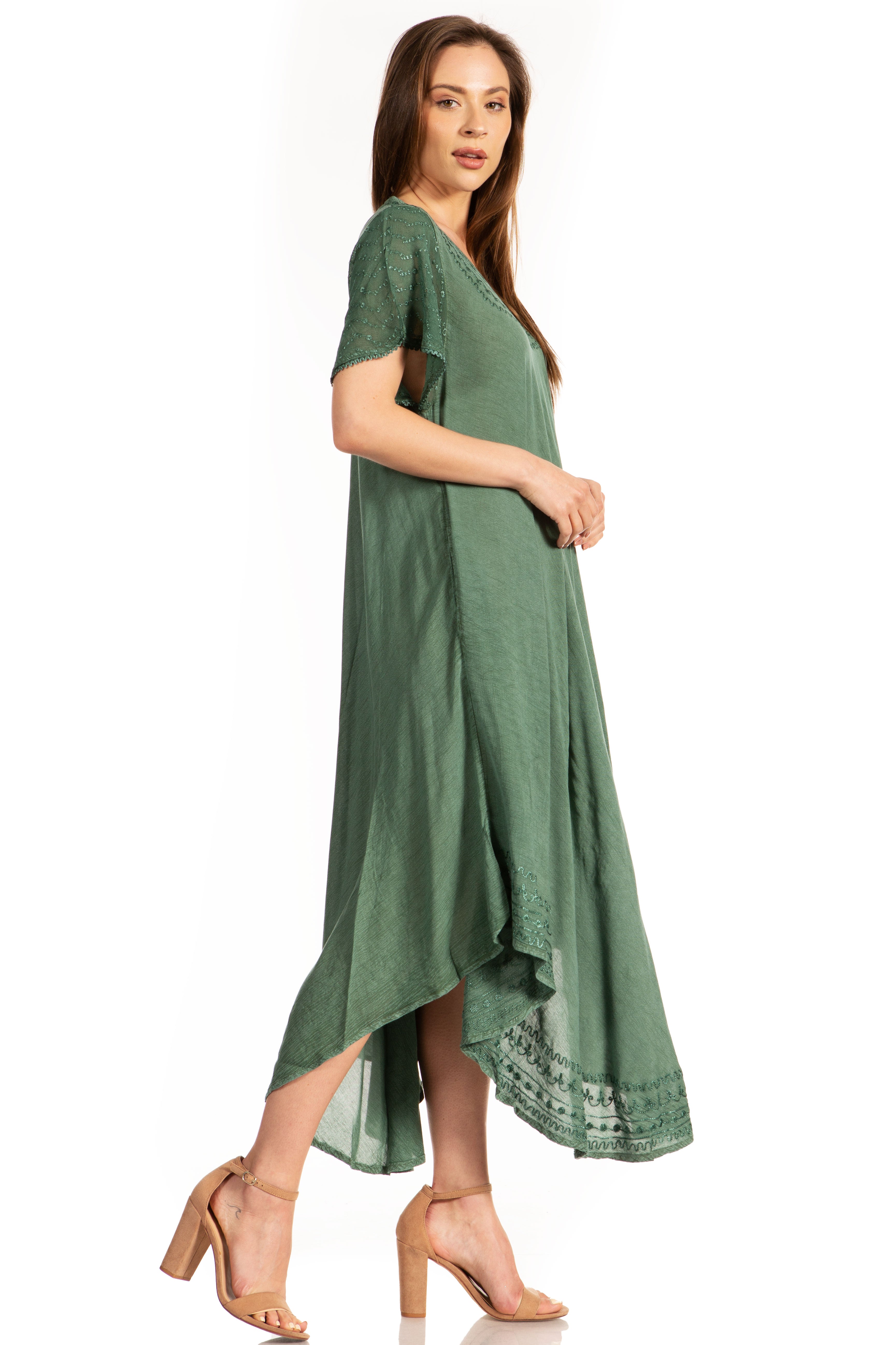 Woman wearing a green dress with a plain background