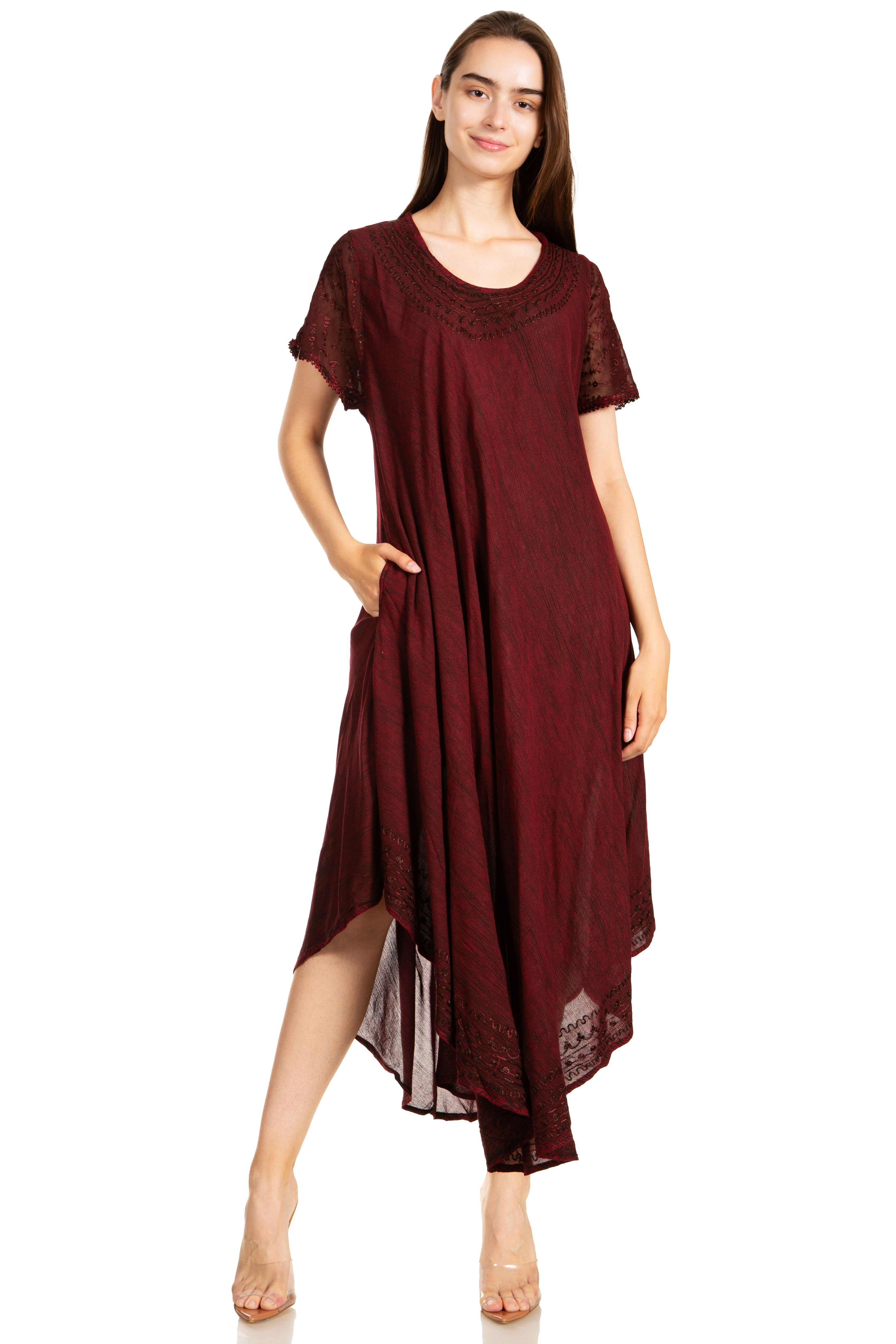 Woman wearing a burgundy dress with lace sleeves on a white background