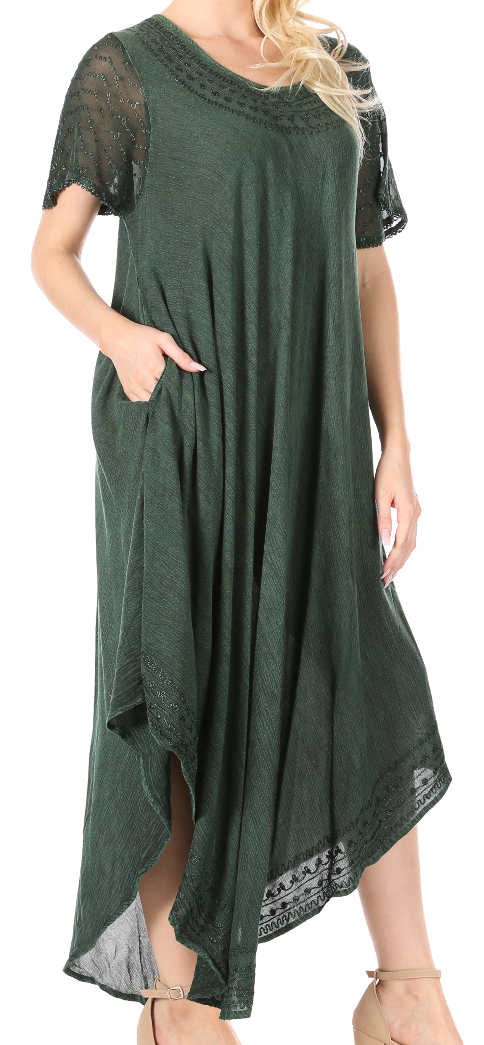 Green dress with lace details on a model against a white background