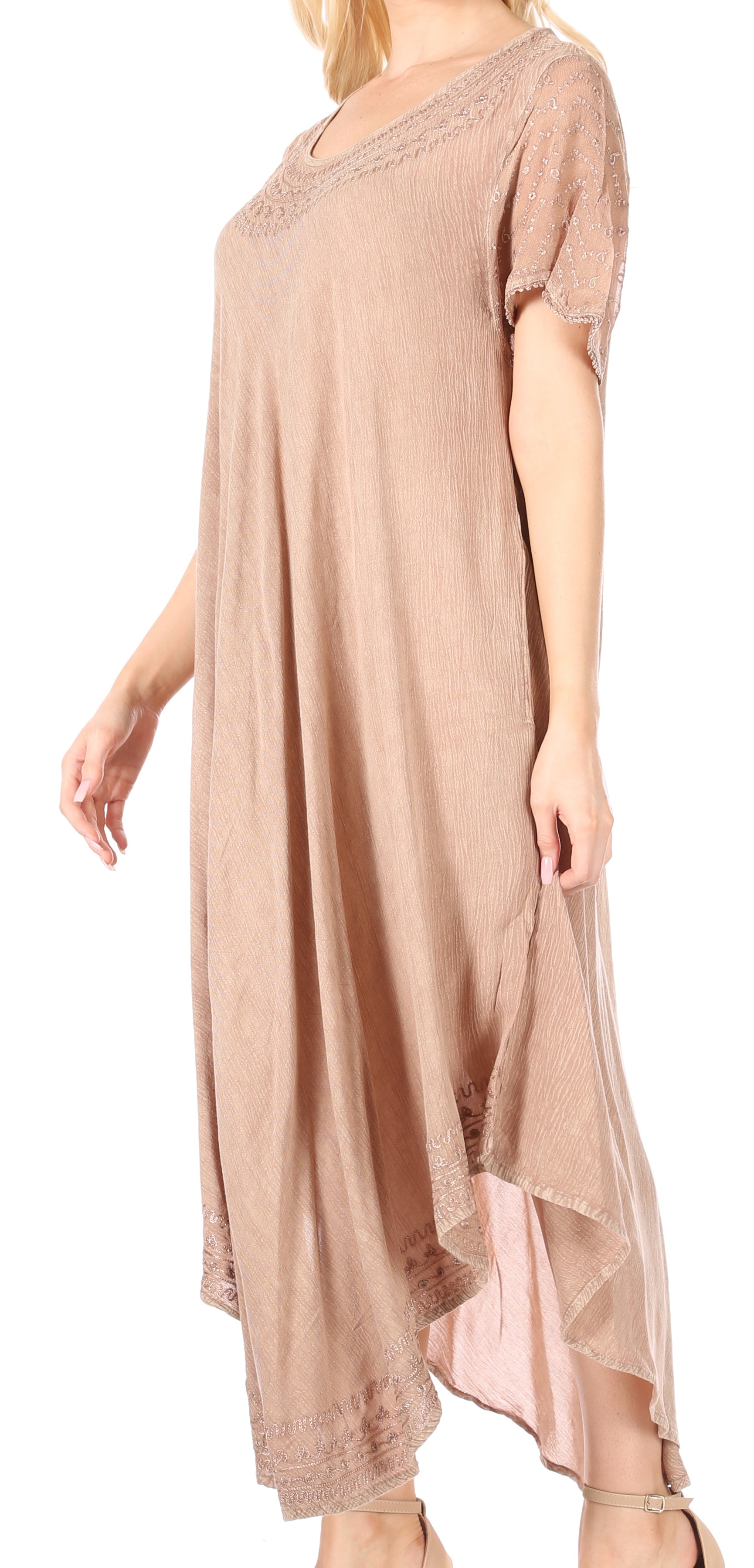 Woman wearing a beige dress with lace details on a white background