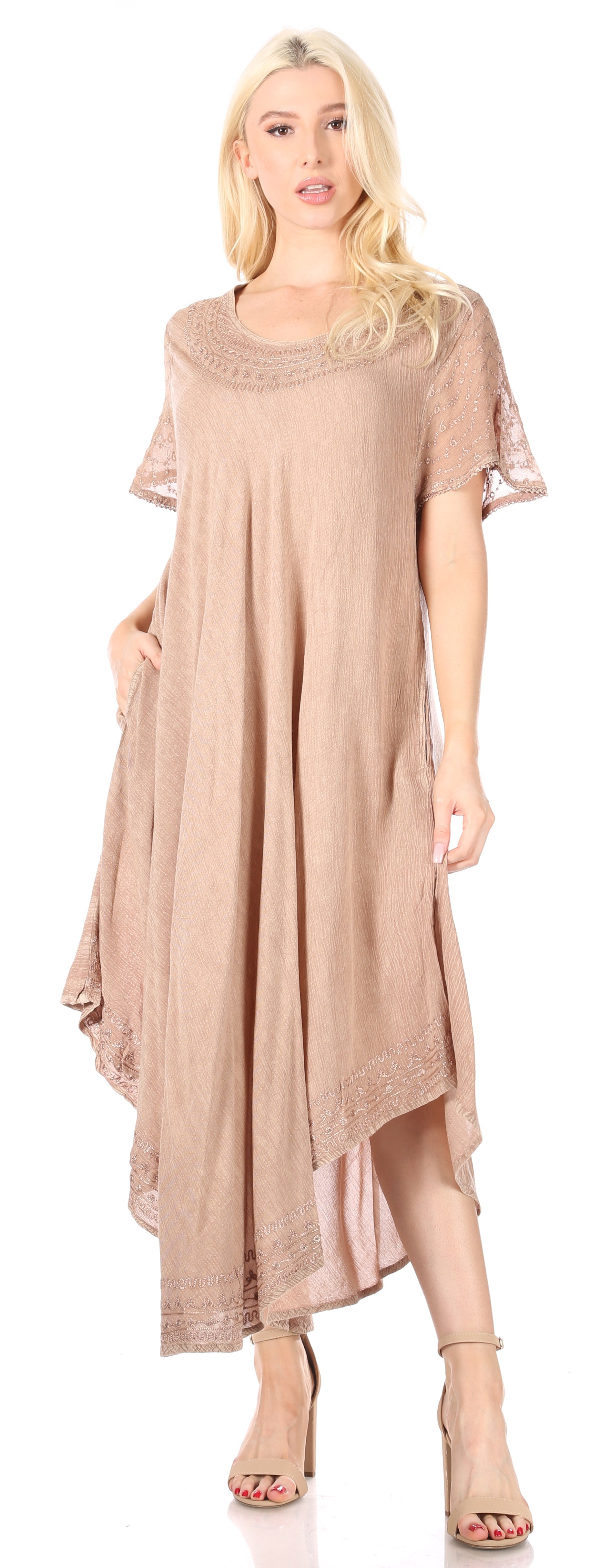 Woman wearing a beige dress with lace details on a white background