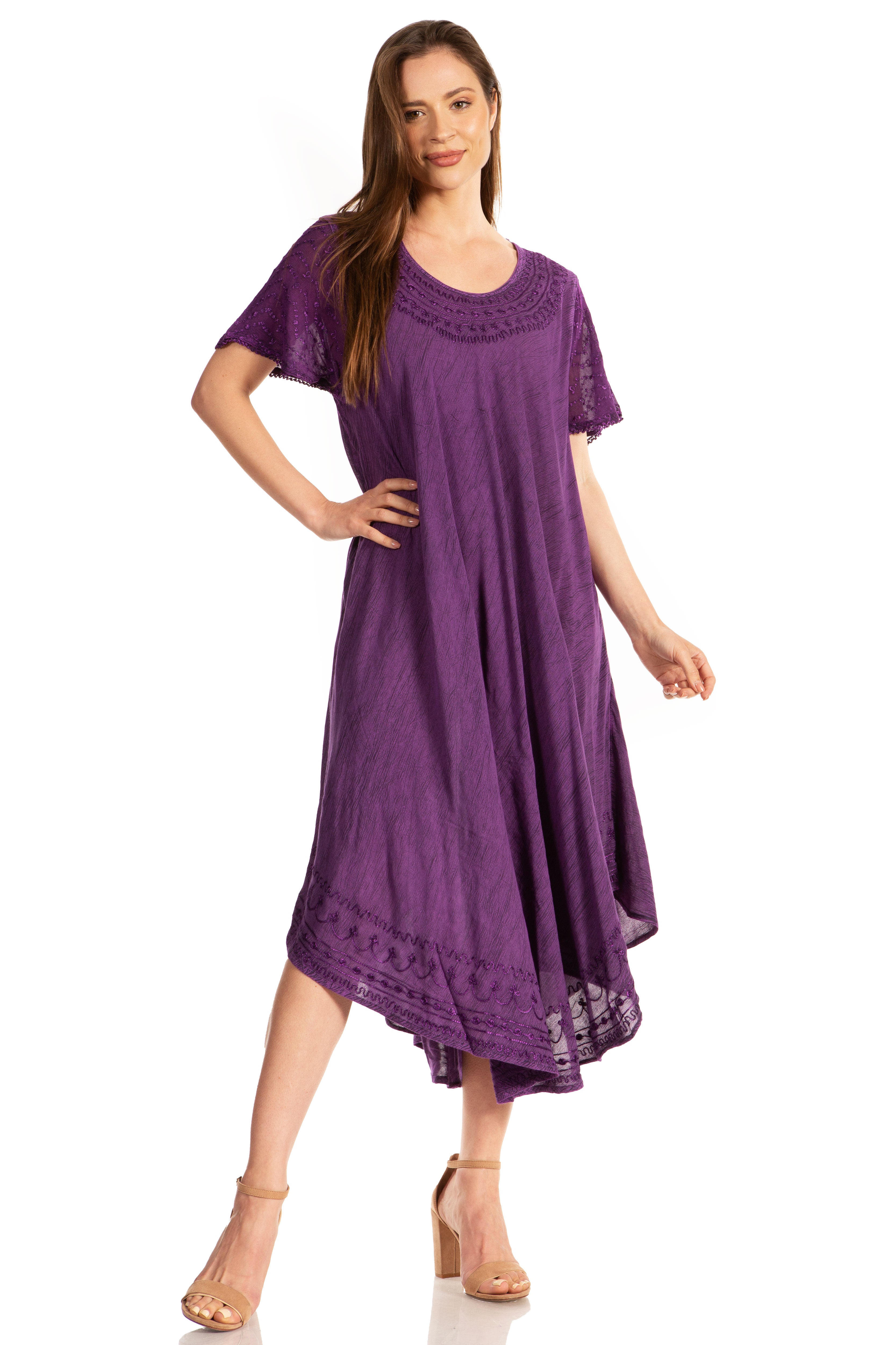 Woman wearing a purple dress with lace details on a white background