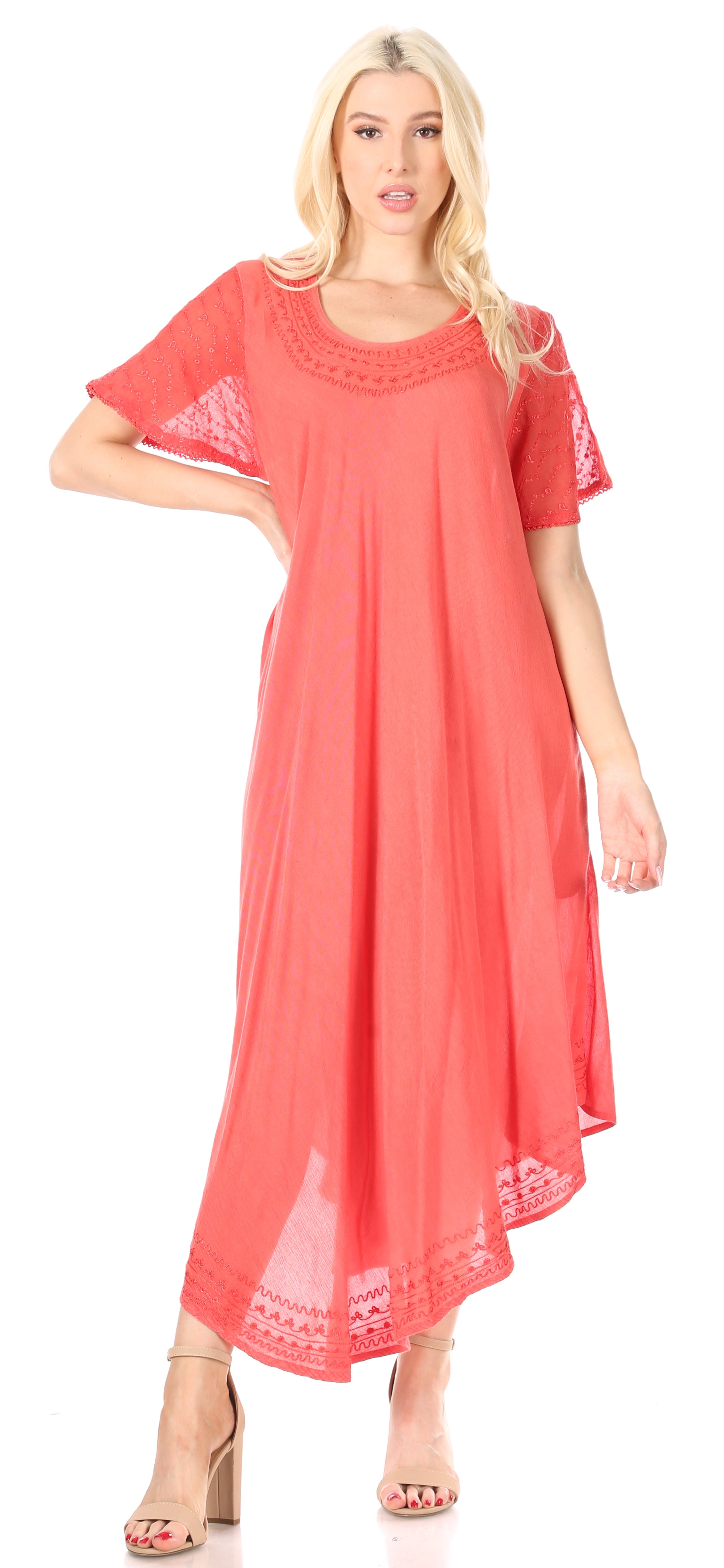 Woman wearing a coral dress with lace details on a white background