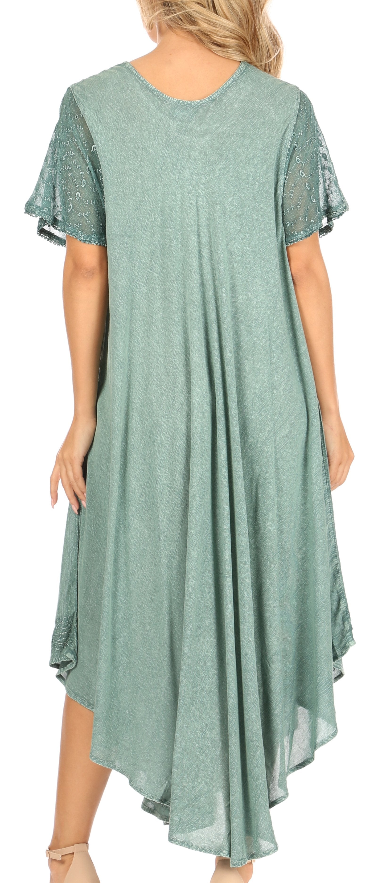 Green dress with lace sleeves worn by a model on a plain background
