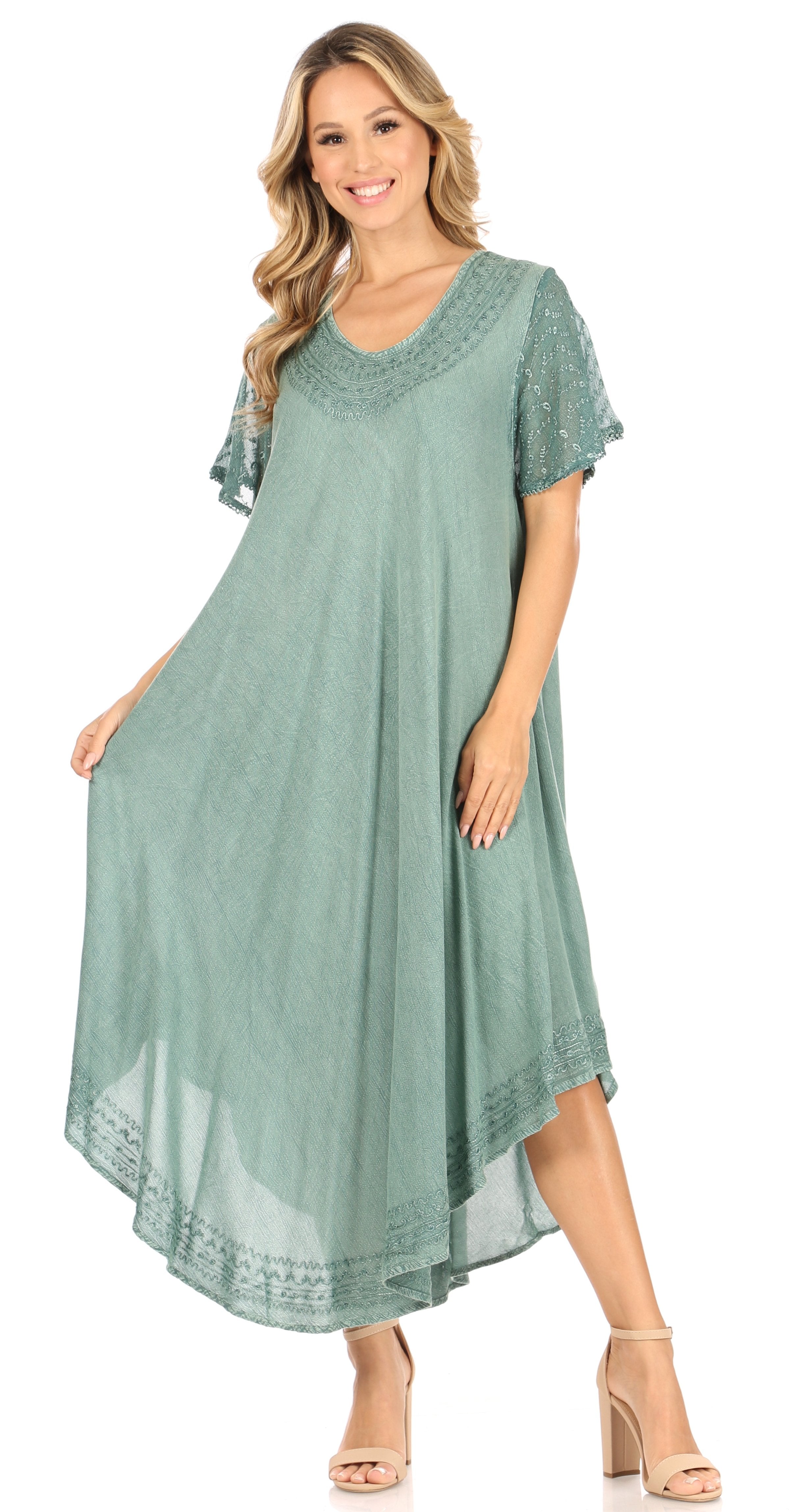Woman wearing a green dress with lace details on a white background
