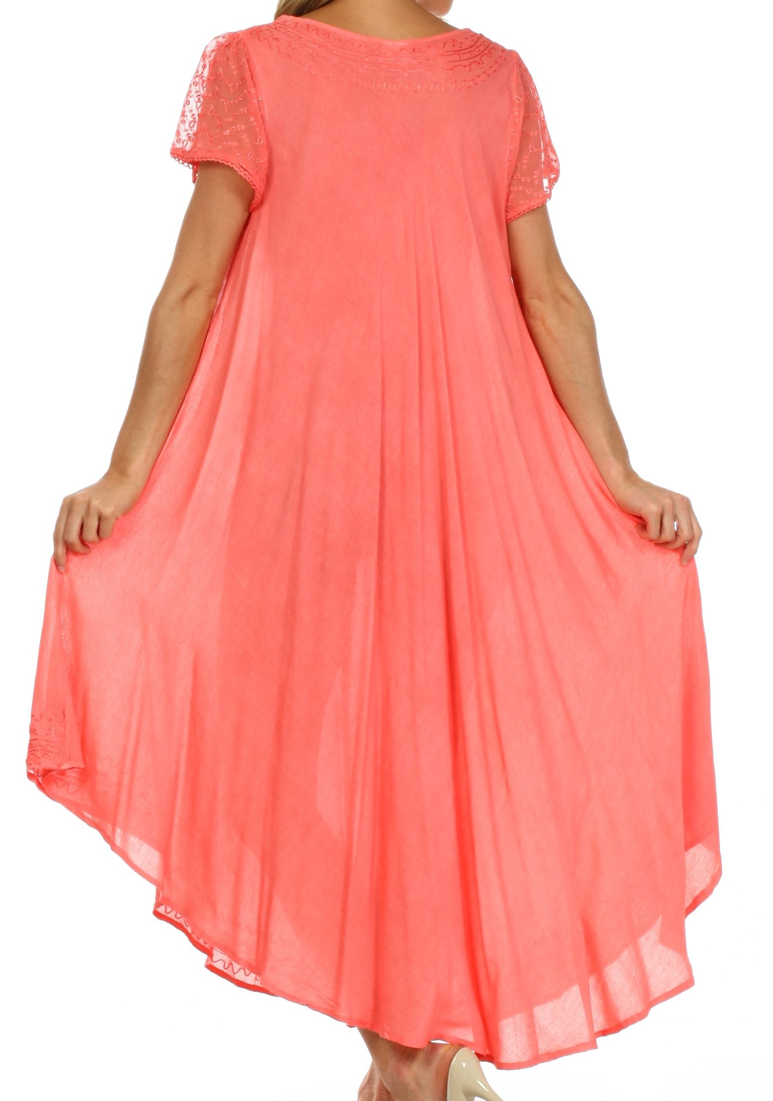 Coral dress with lace details on a white background