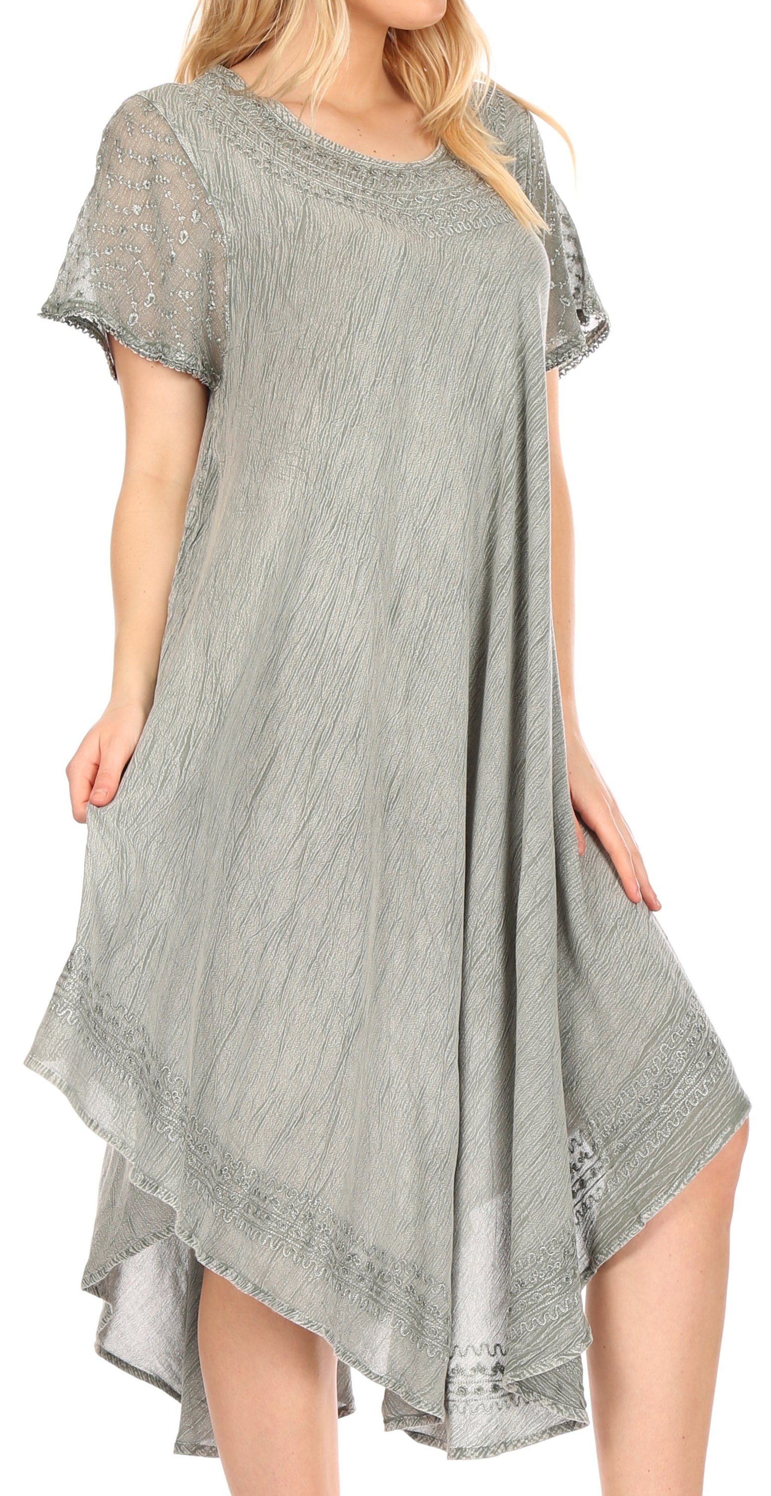 Woman wearing a gray dress with lace details on a white background
