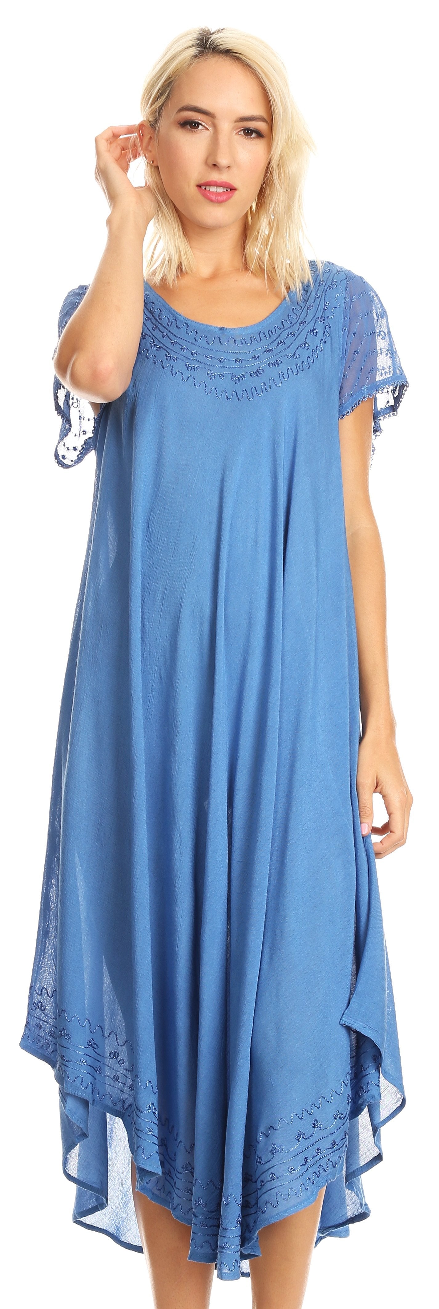 Woman wearing a blue dress with lace details on a white background