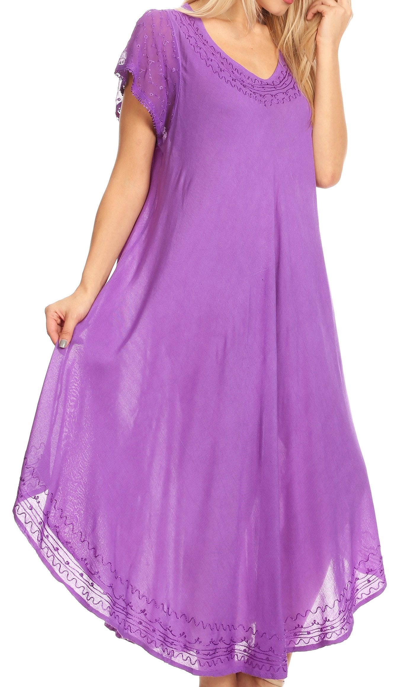 Woman wearing a purple dress with lace details on a white background