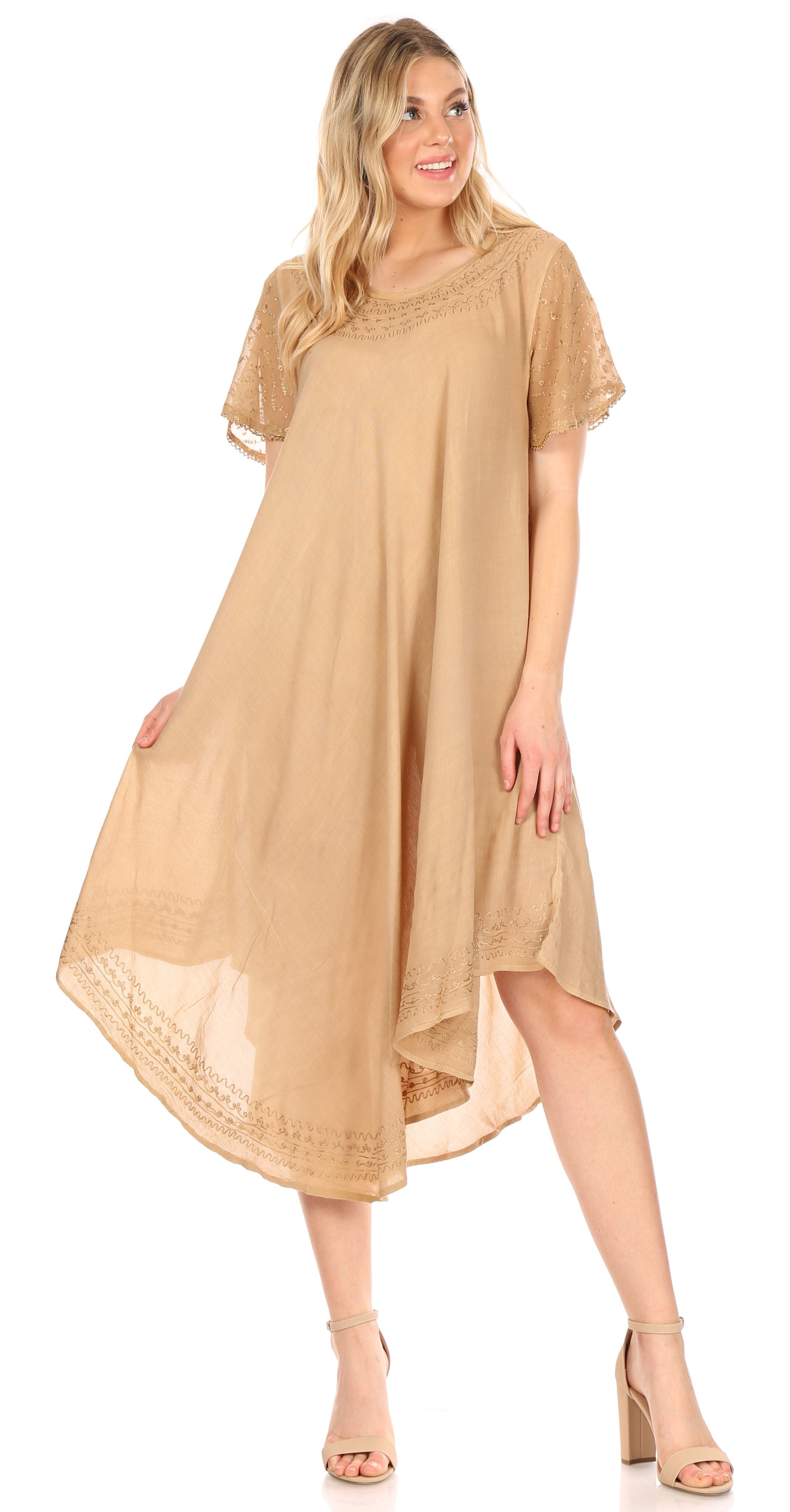 Woman wearing a beige dress with lace details on a white background