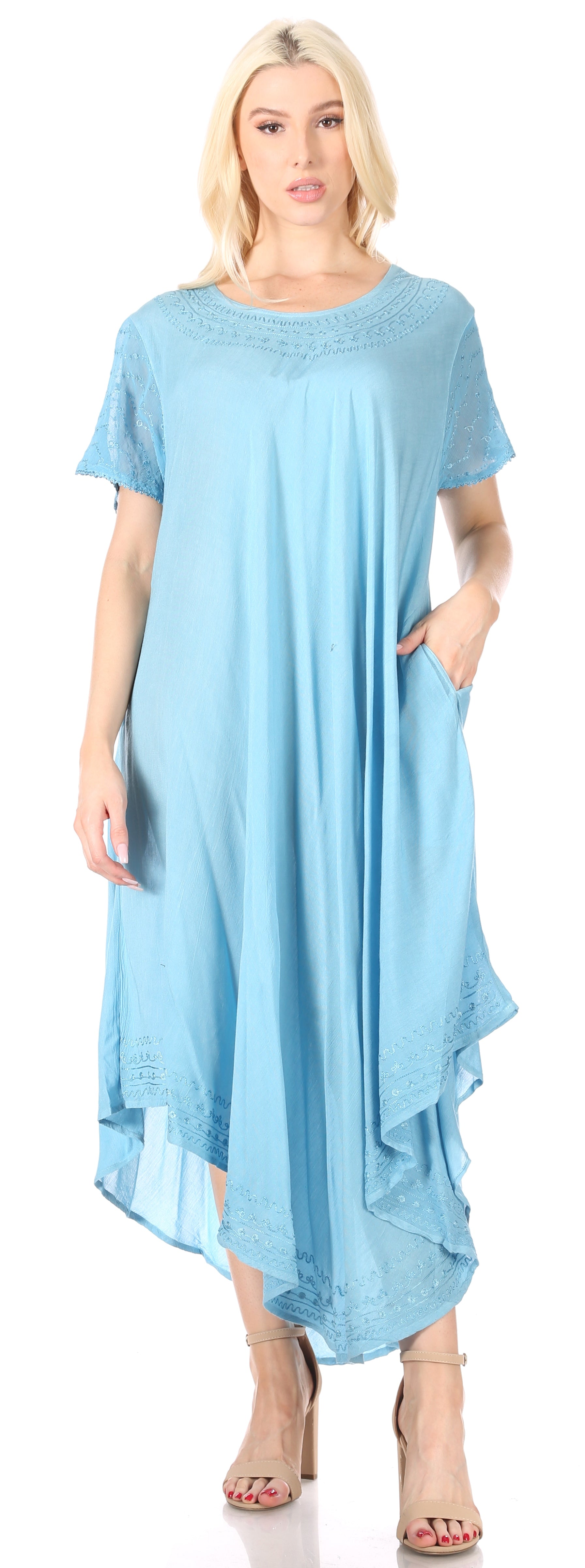 Woman wearing a light blue dress with a plain background