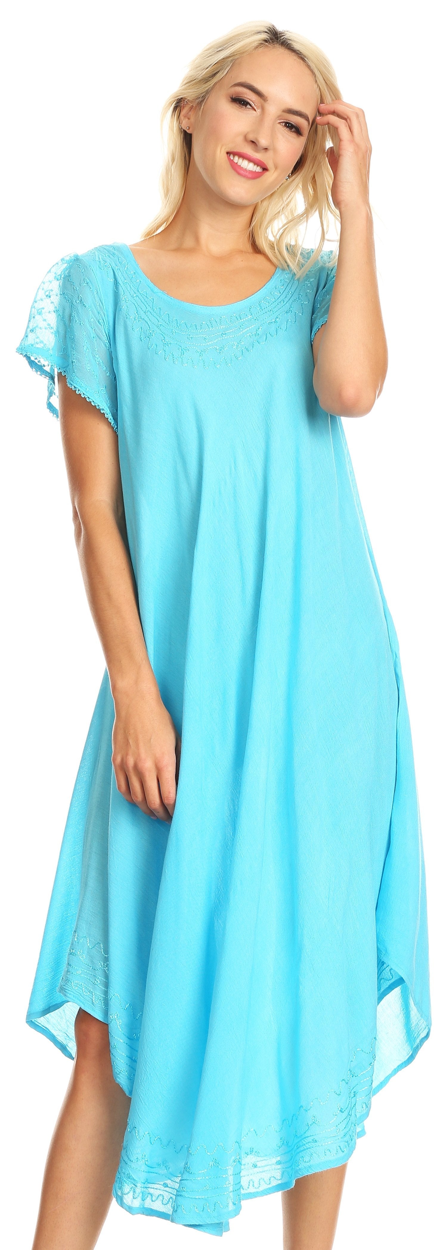 Woman wearing a light blue dress with lace sleeves against a neutral background