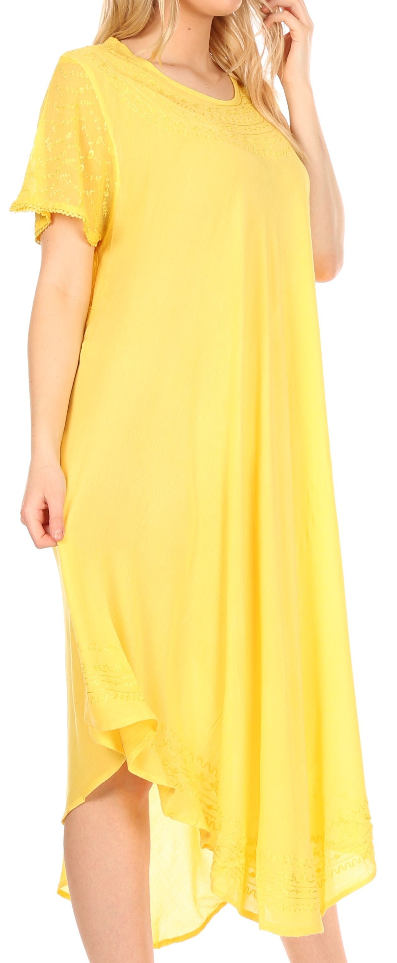 Woman wearing a yellow dress with a flowing design.