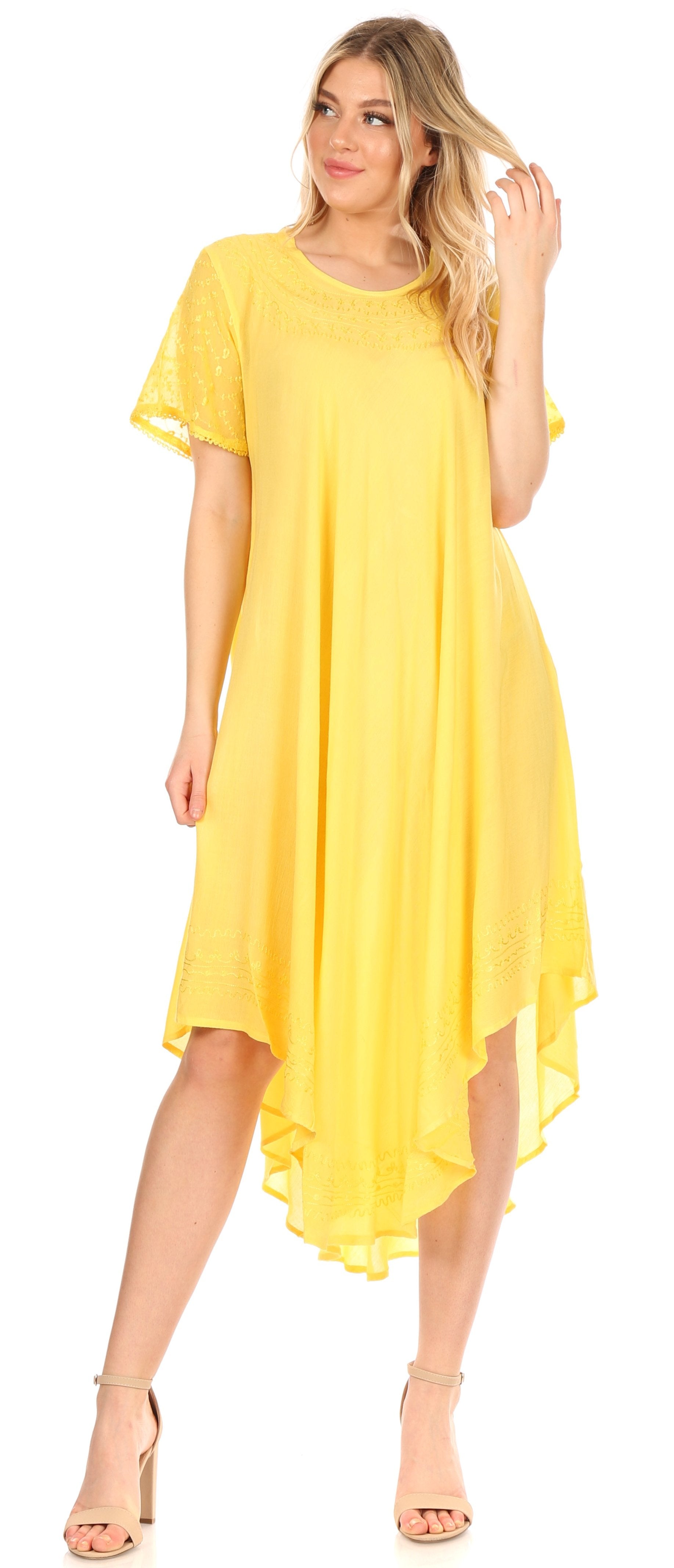 Woman wearing a yellow dress with a plain background