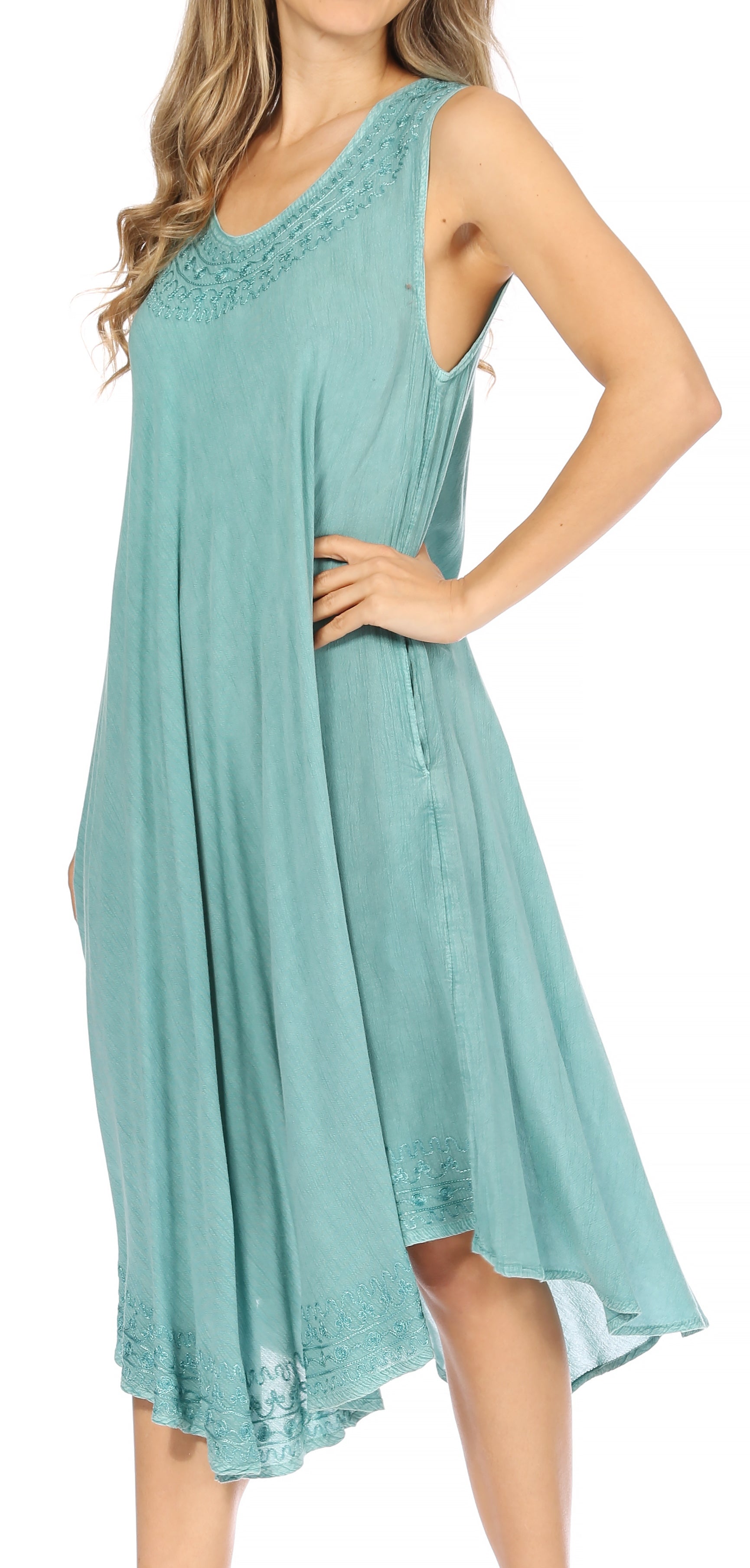 Woman wearing a light blue dress with lace details on a white background