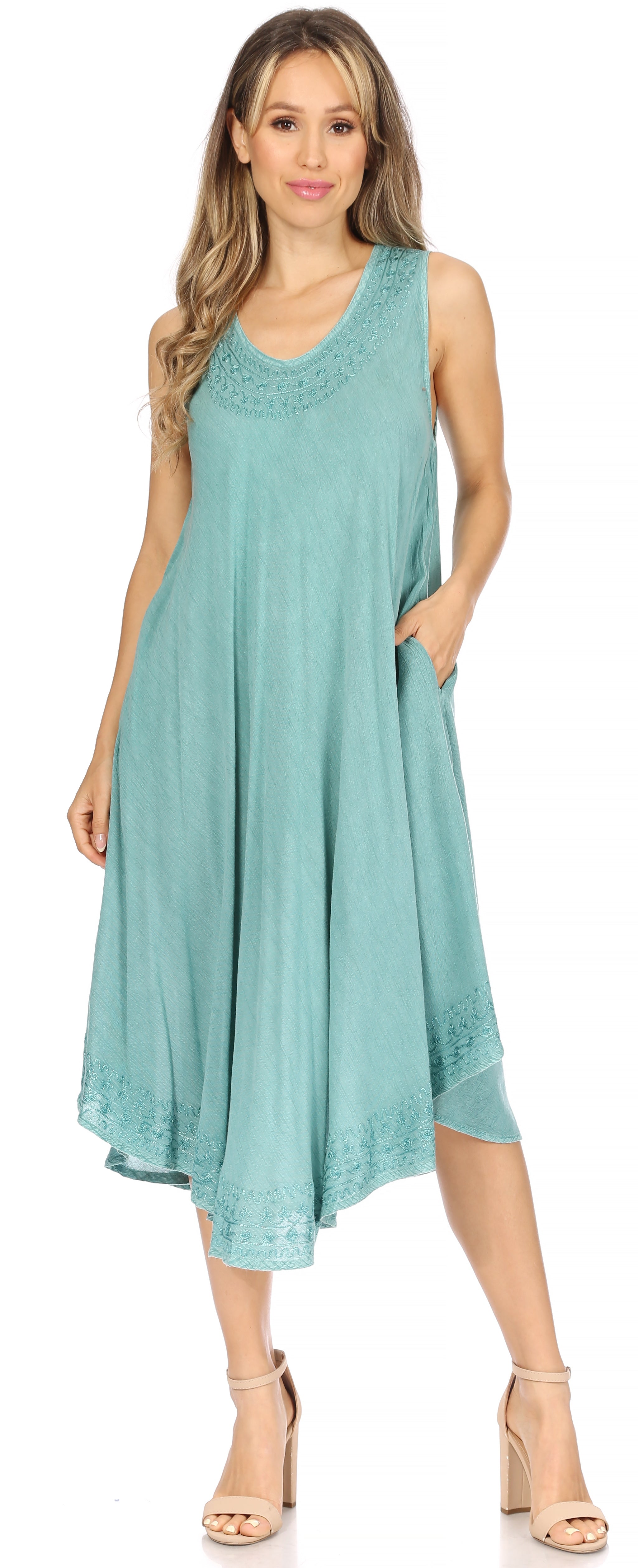 Woman wearing a light blue sleeveless dress on a white background
