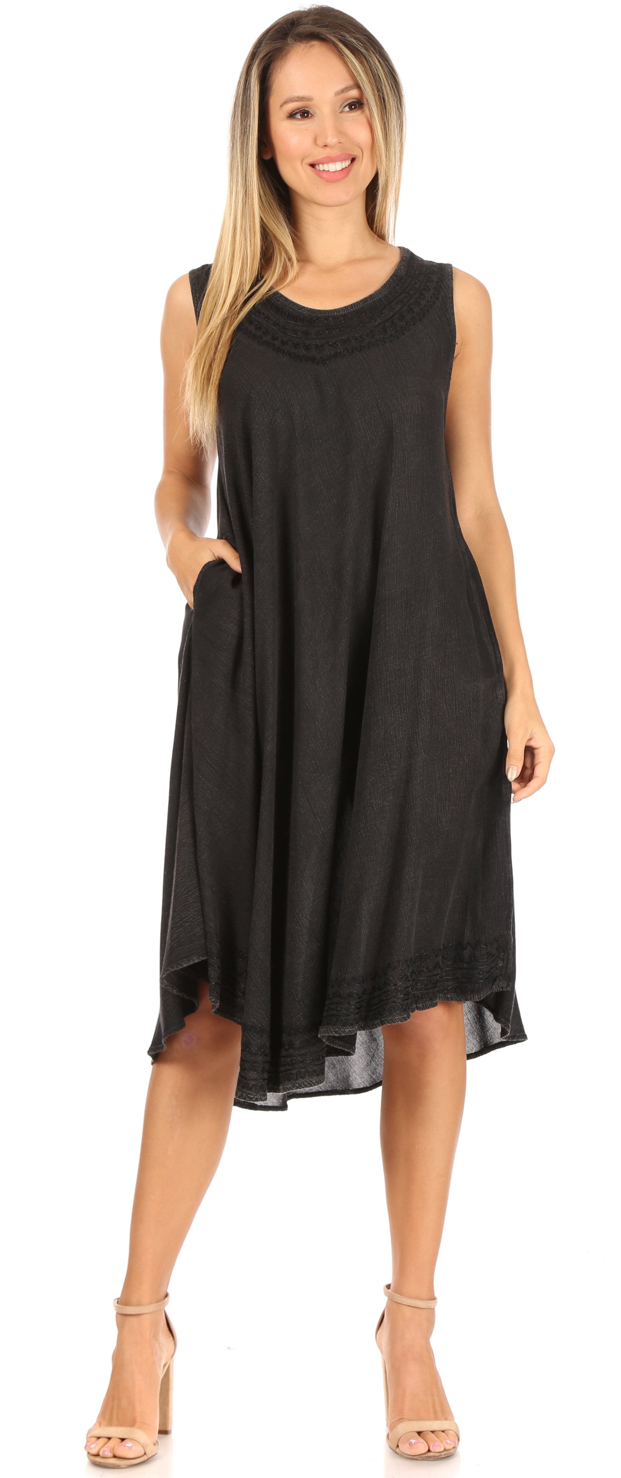 Woman wearing a black sleeveless dress on a white background