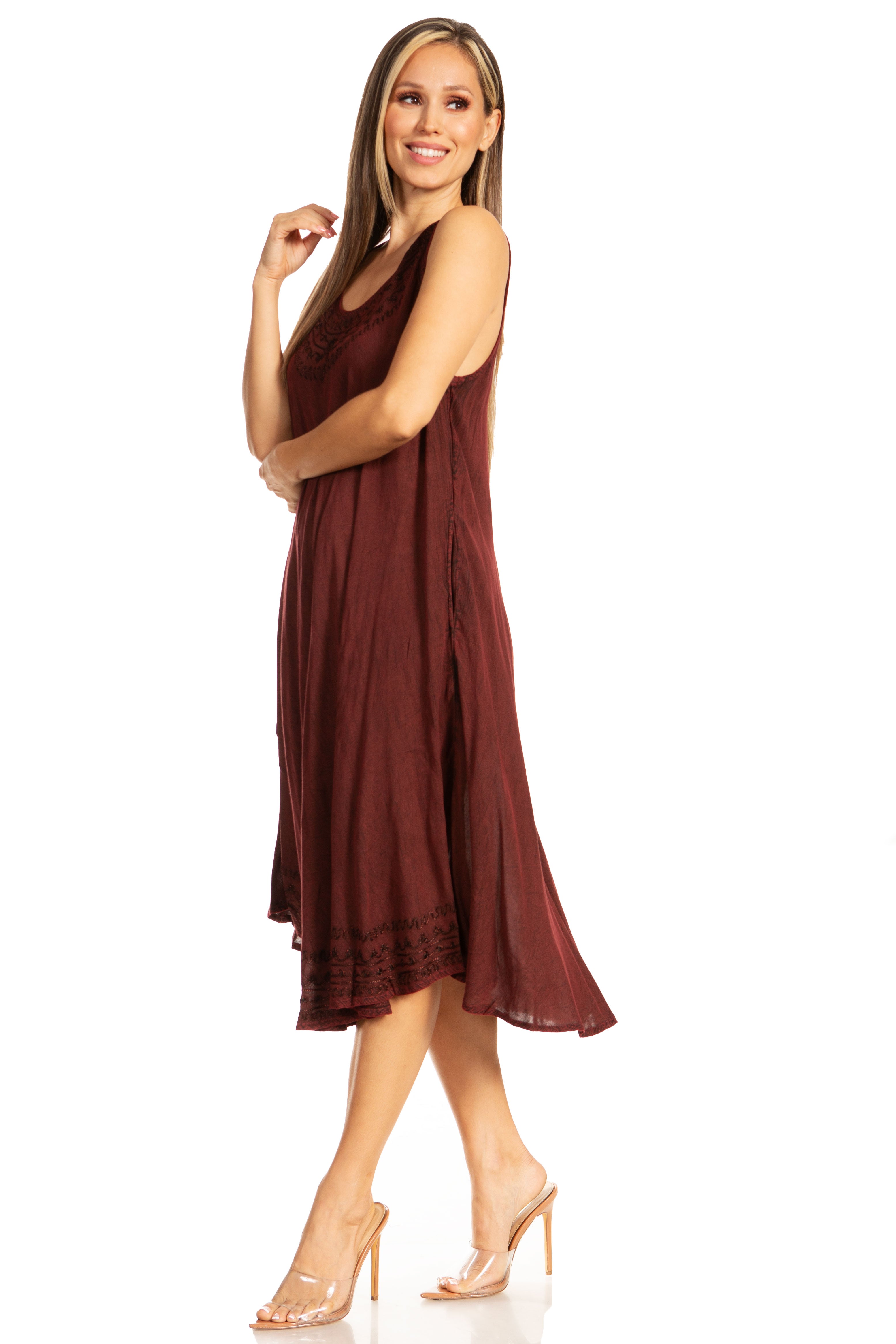 Woman wearing a burgundy sleeveless dress on a white background