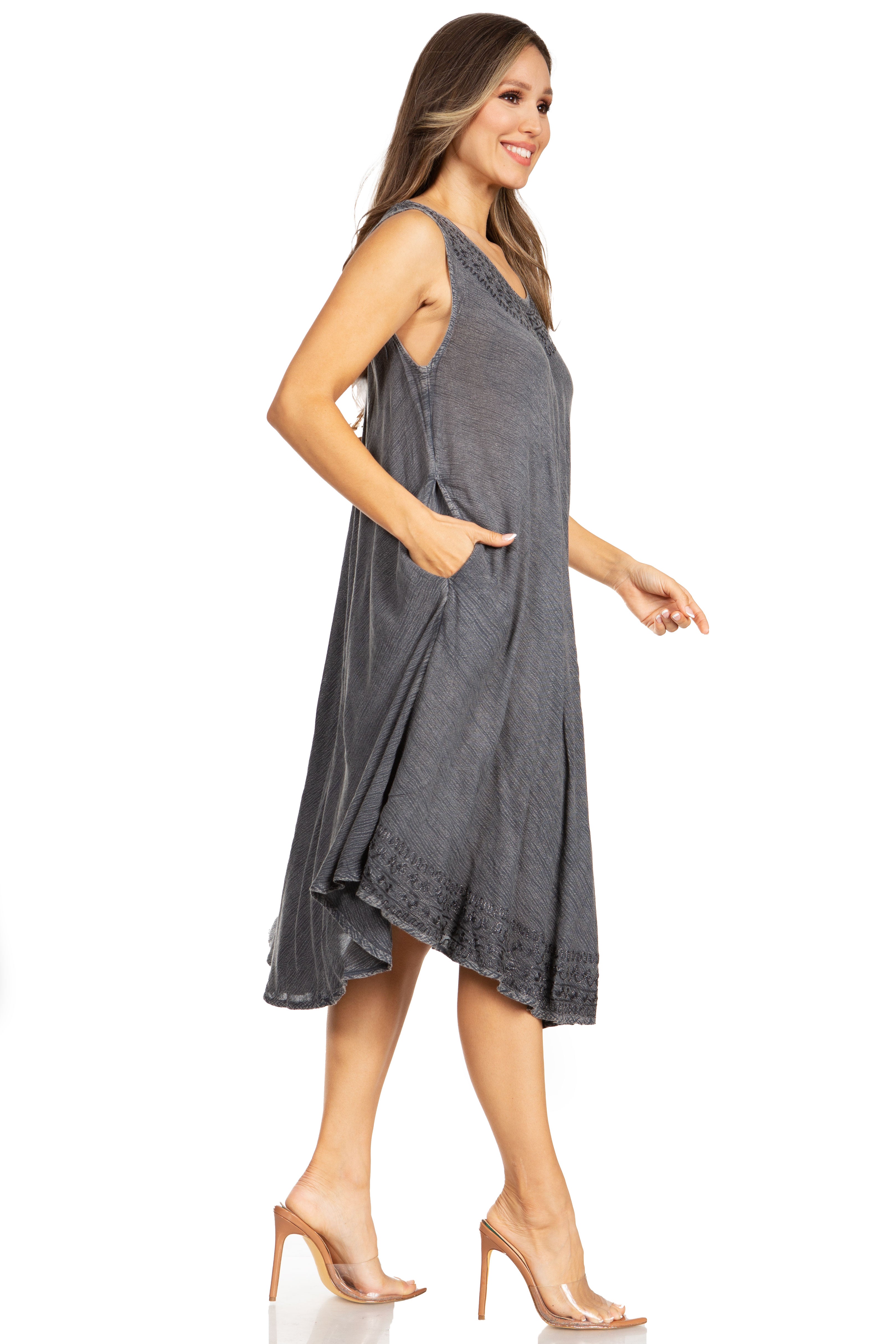 Woman wearing a gray sleeveless dress on a white background