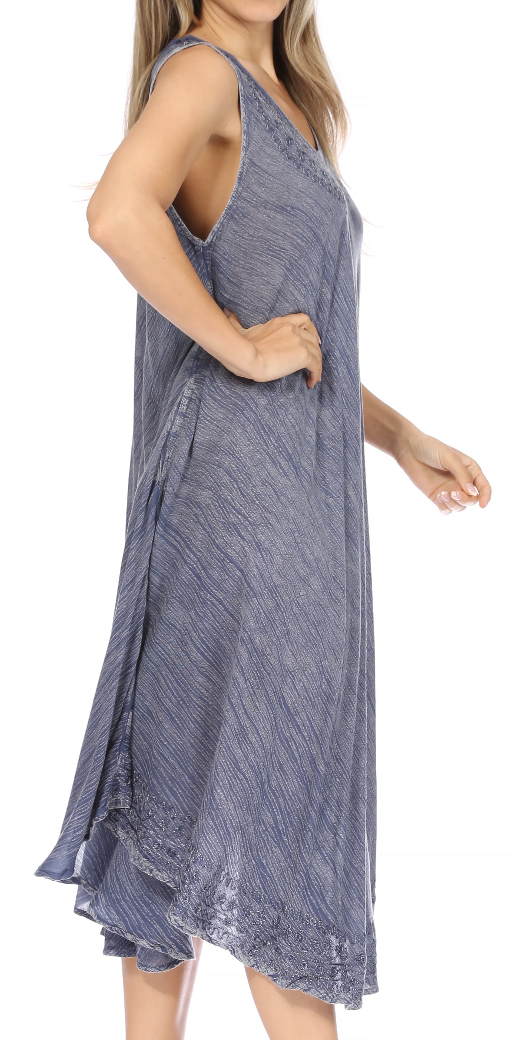 Woman wearing a sleeveless blue dress on a white background