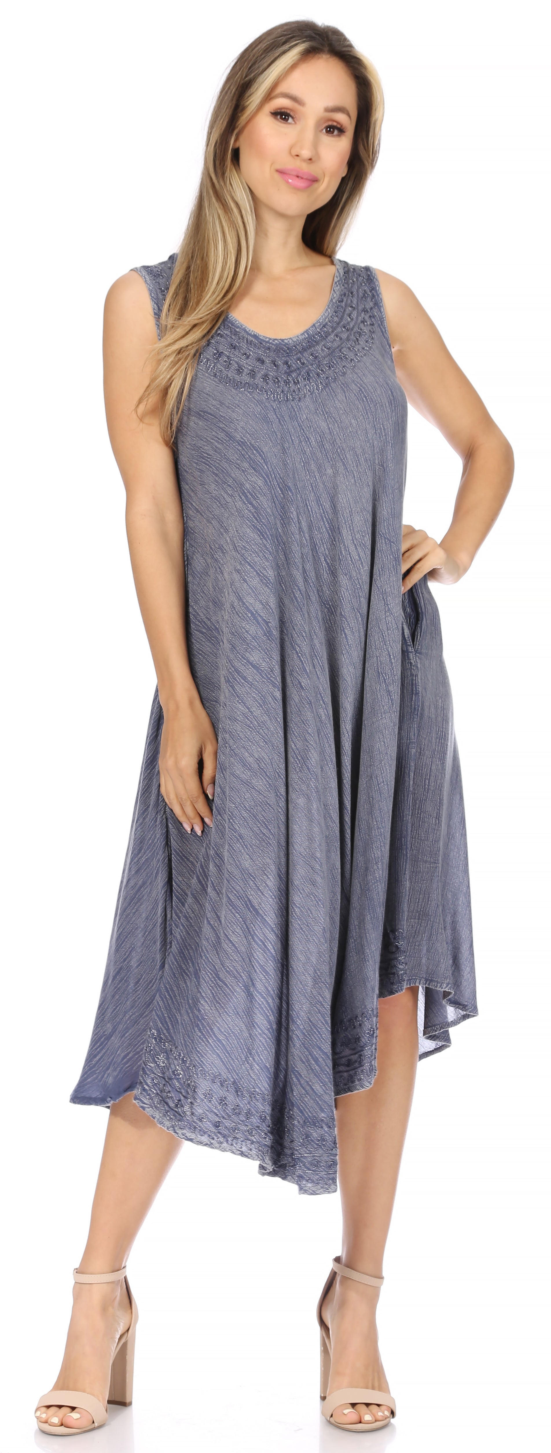 Woman wearing a blue sleeveless dress on a white background