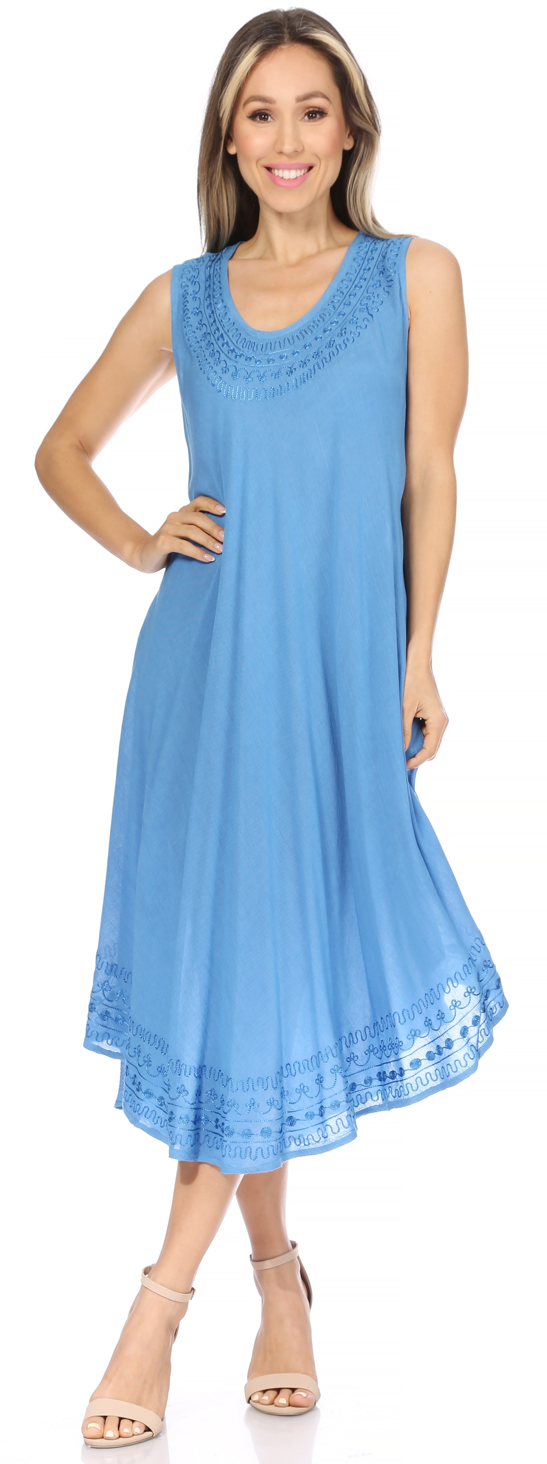 Woman wearing a light blue sleeveless dress with lace details on a white background