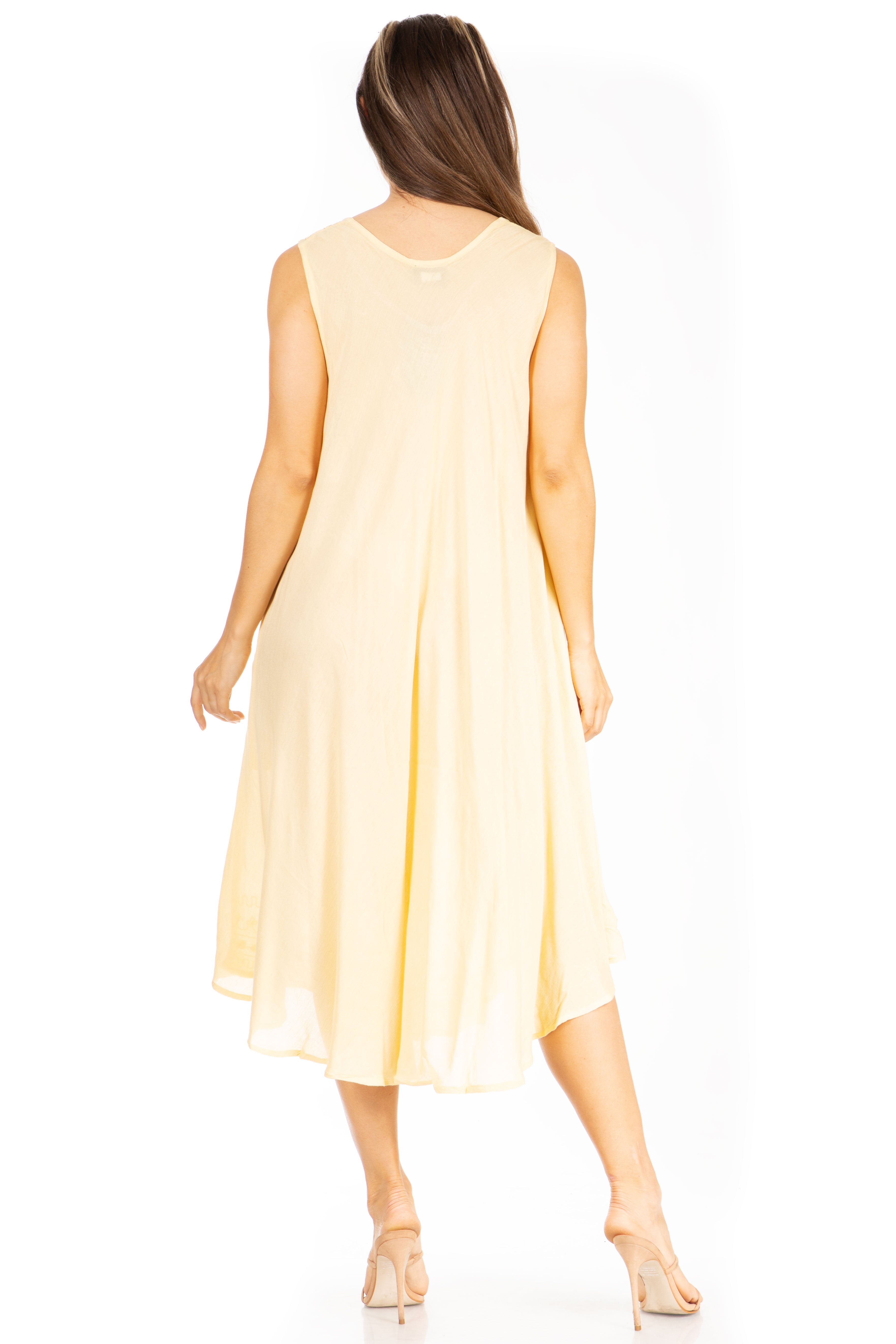 Woman wearing a light yellow sleeveless dress on a white background