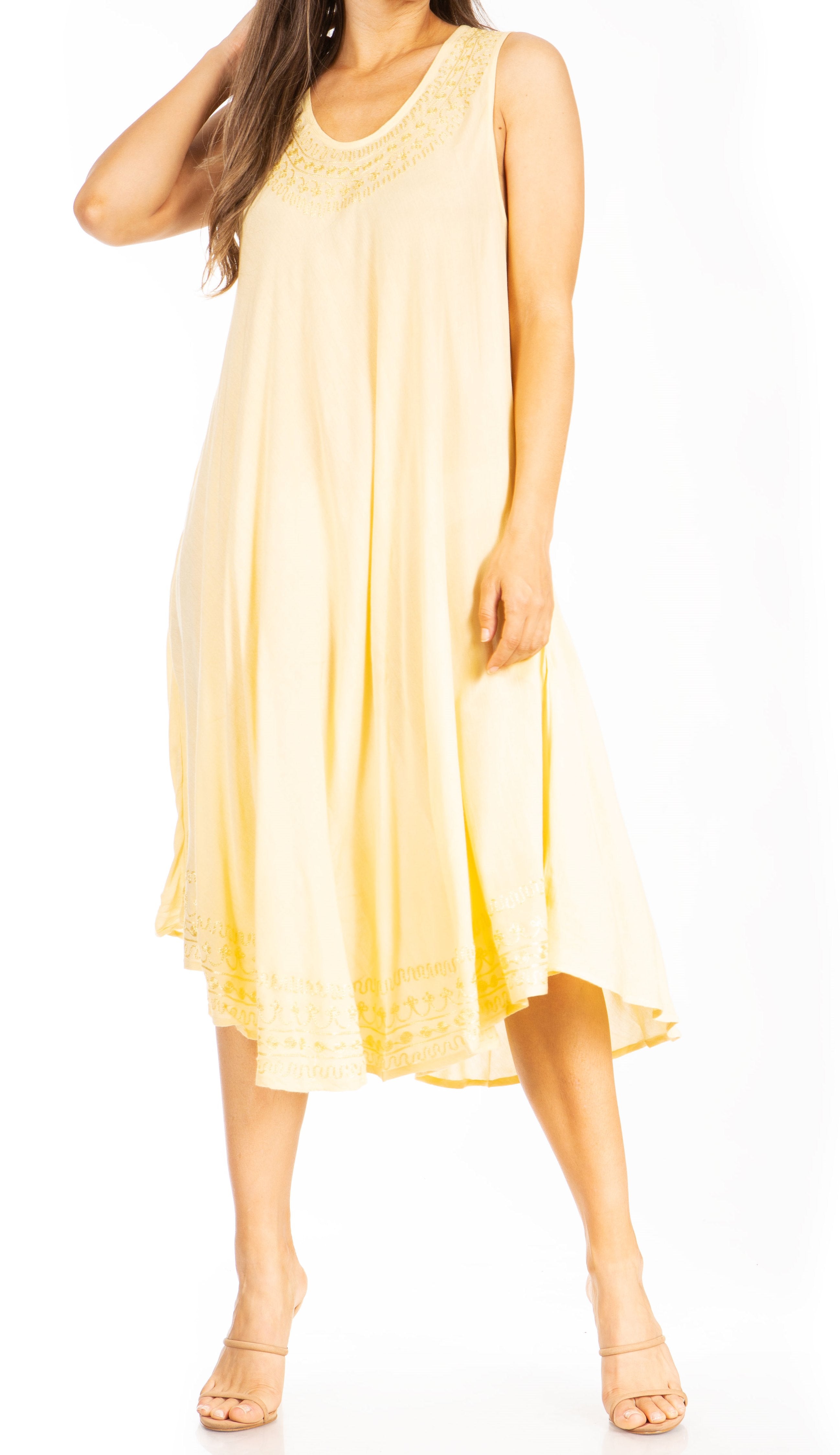 Woman wearing a yellow sleeveless dress on a white background