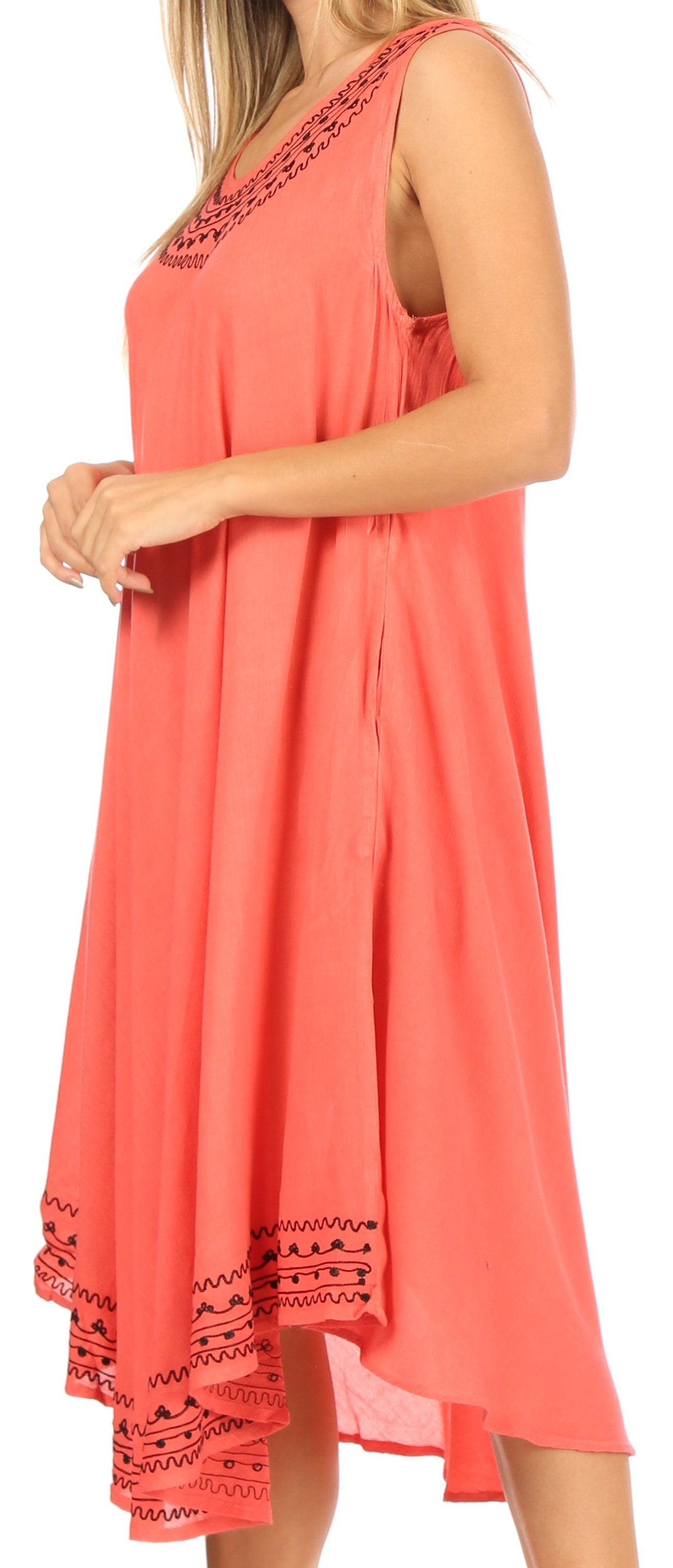 Coral dress with black lace details on a white background