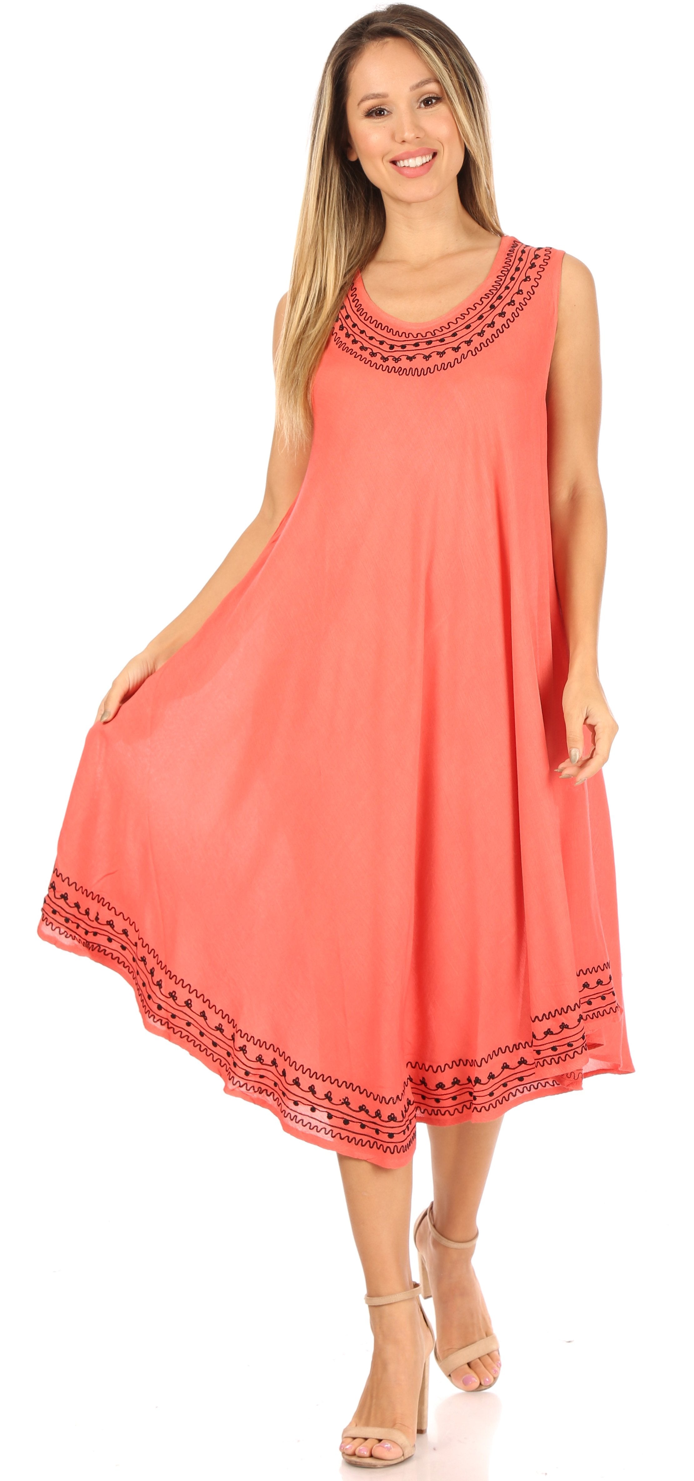 Woman wearing a coral dress with lace details on a white background