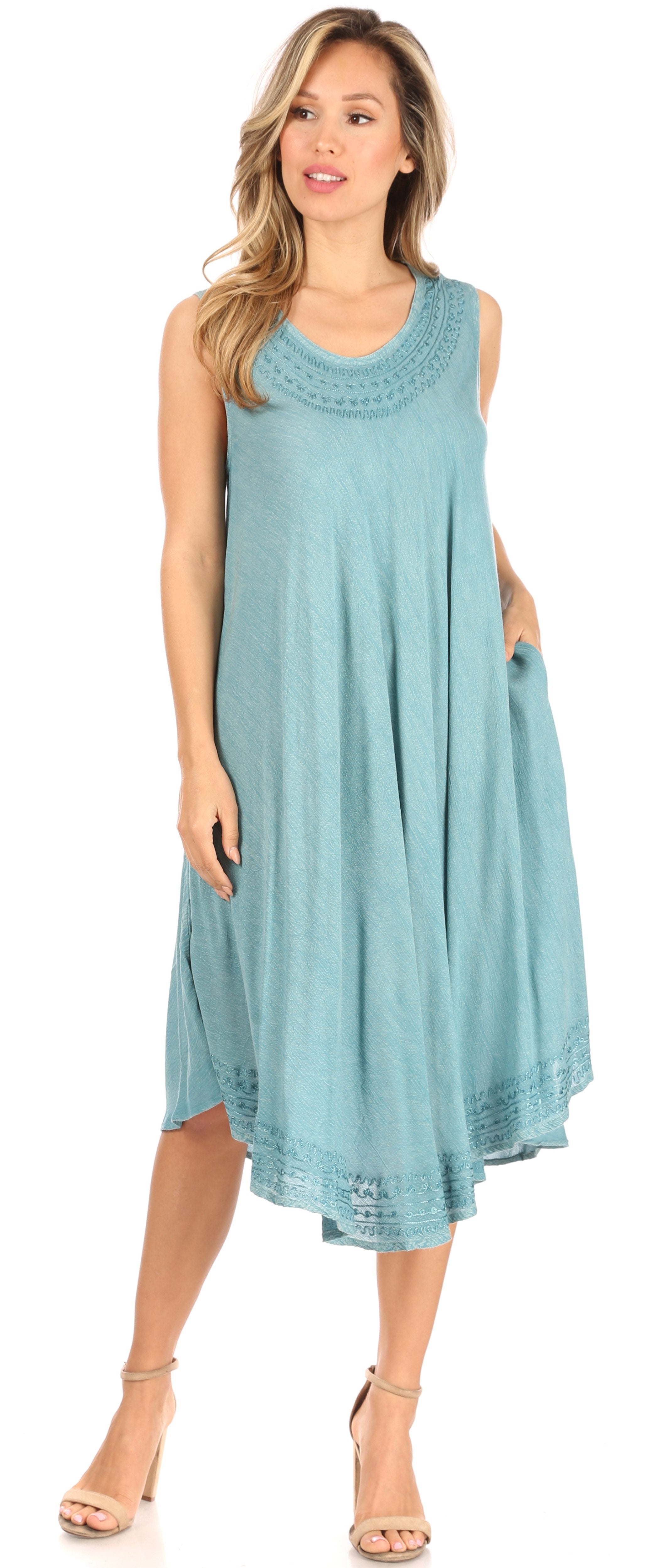 Woman wearing a light blue sleeveless dress with a decorative neckline.