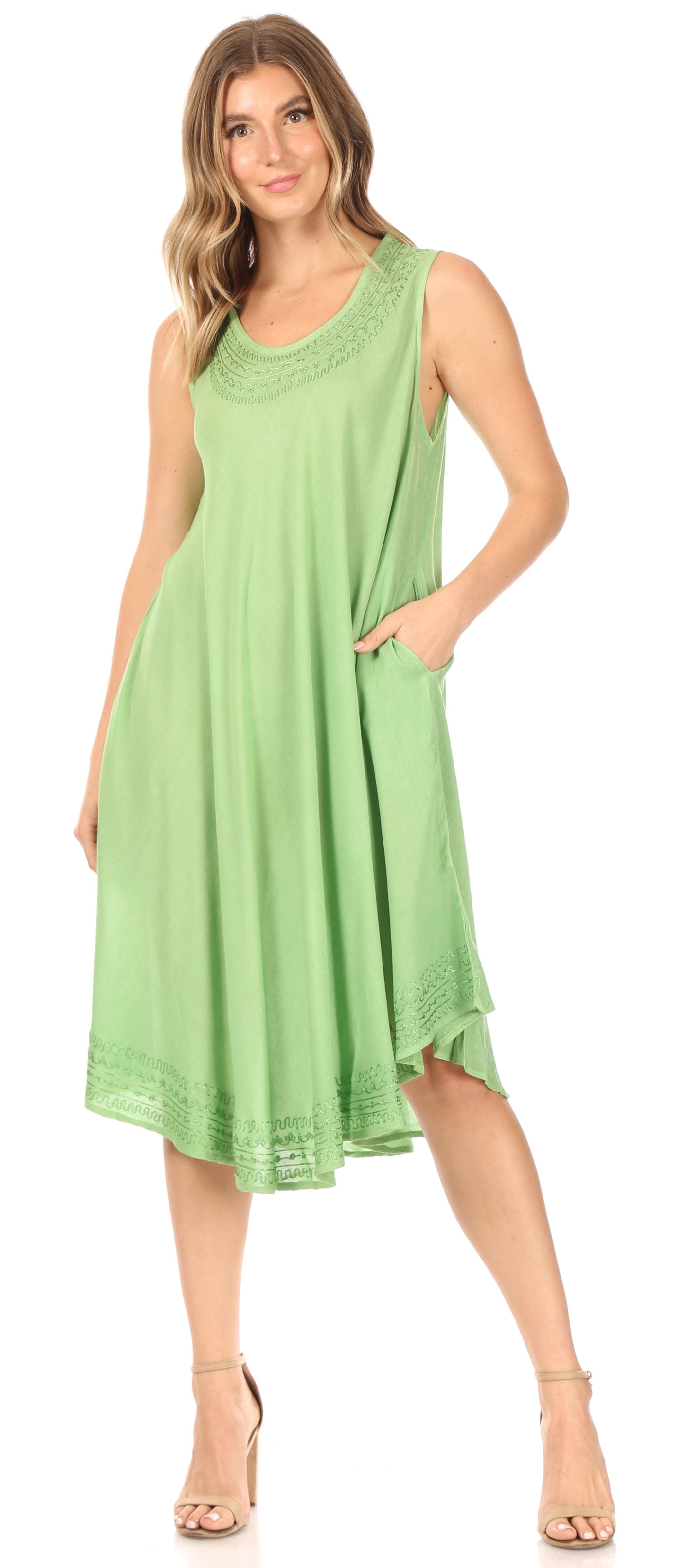 Woman wearing a green sleeveless dress on a white background
