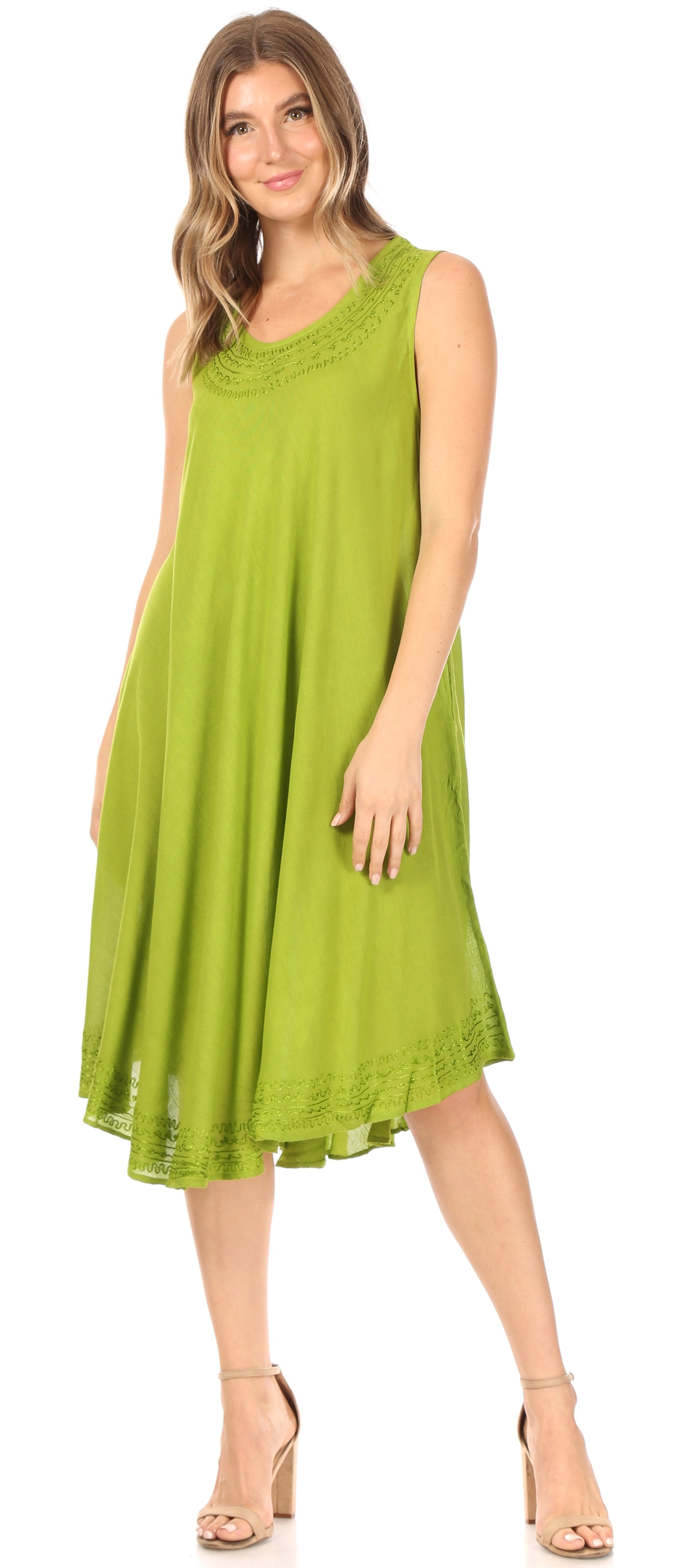 Woman wearing a green sleeveless dress on a white background