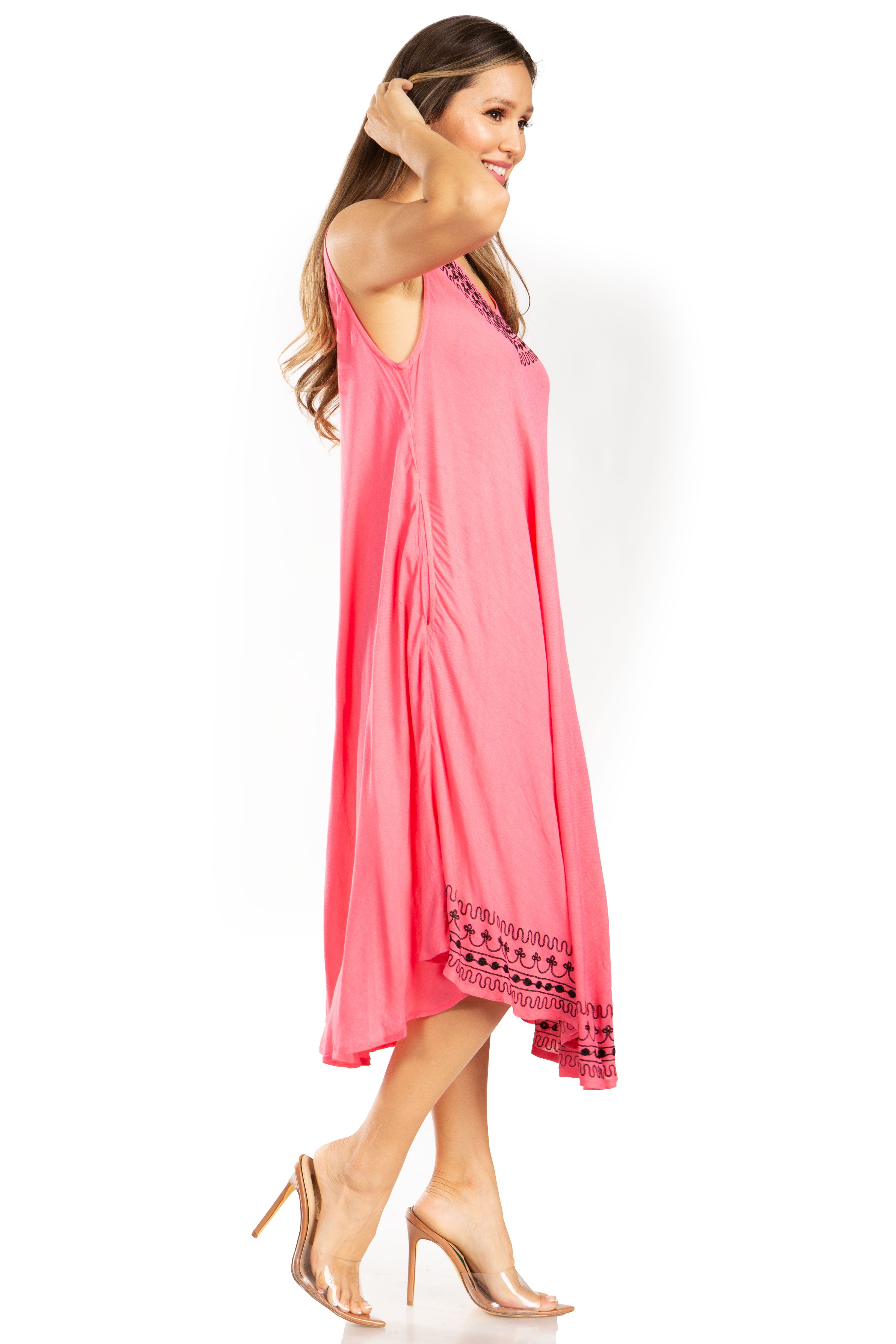 Woman wearing a pink dress with lace details on a white background