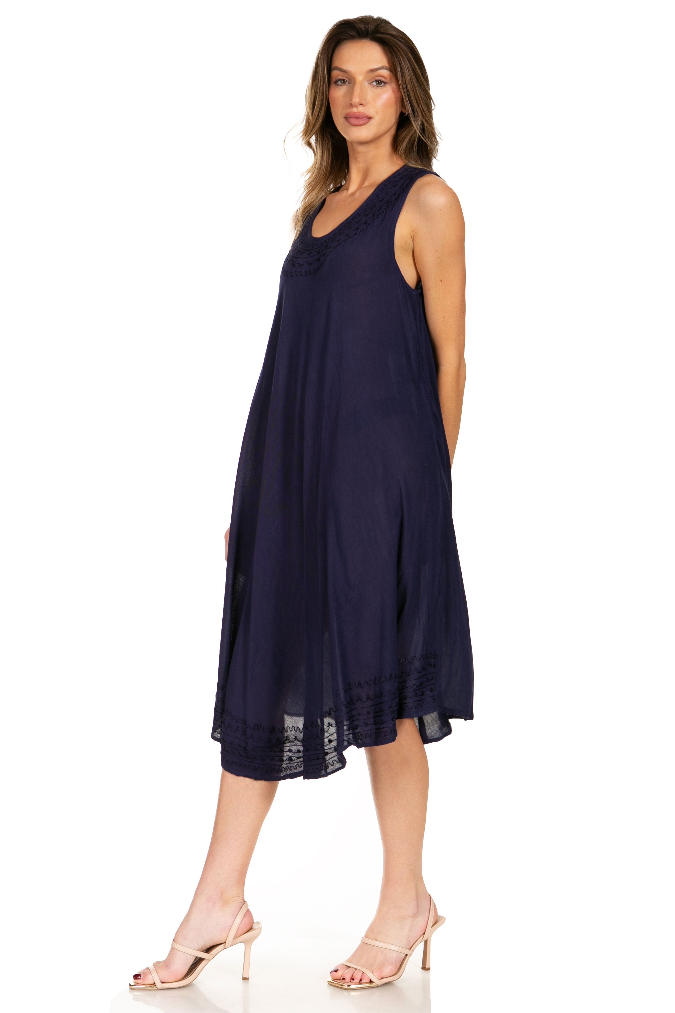 Woman wearing a navy sleeveless dress on a white background