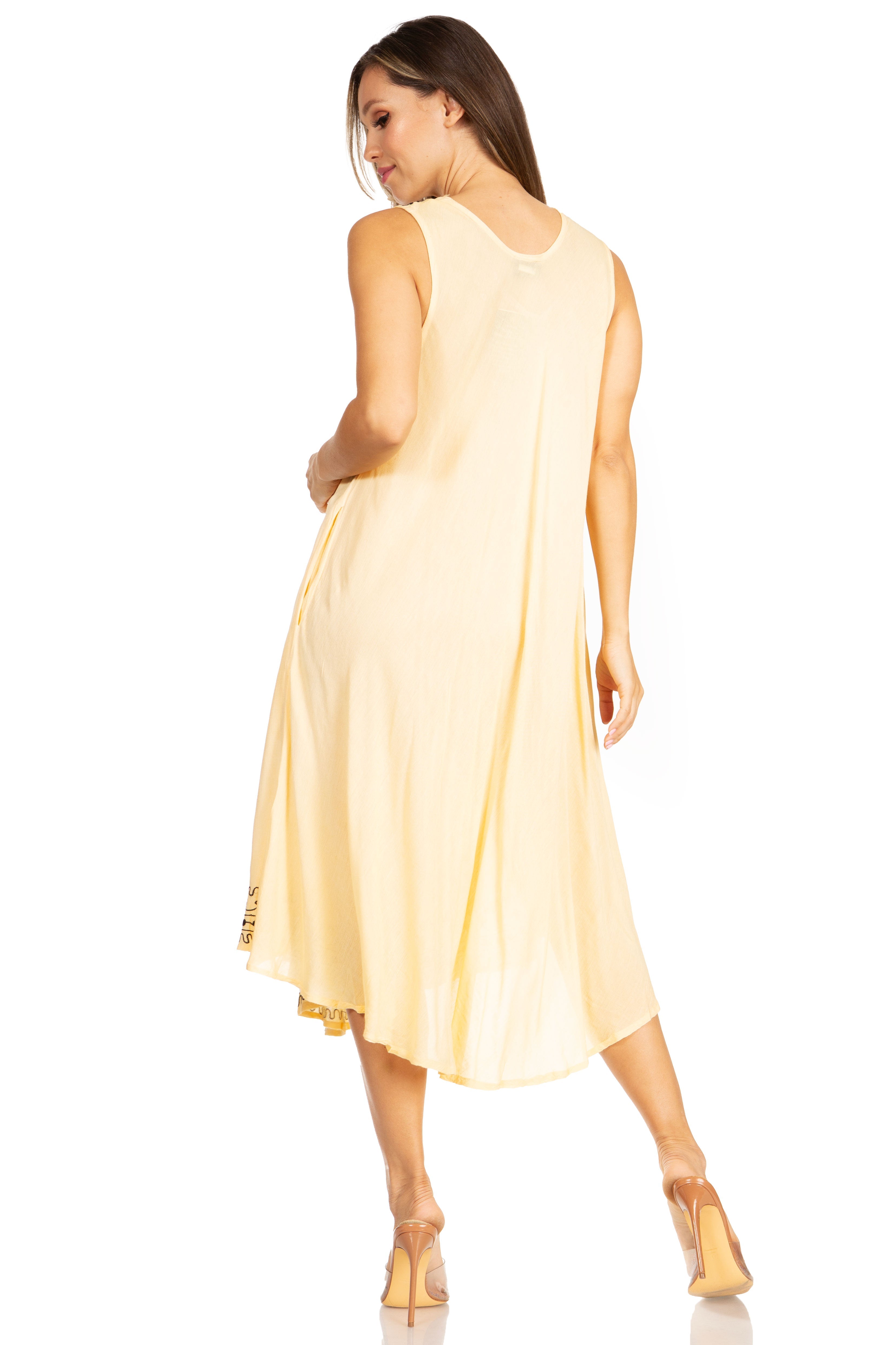 Woman wearing a light yellow sleeveless dress on a white background
