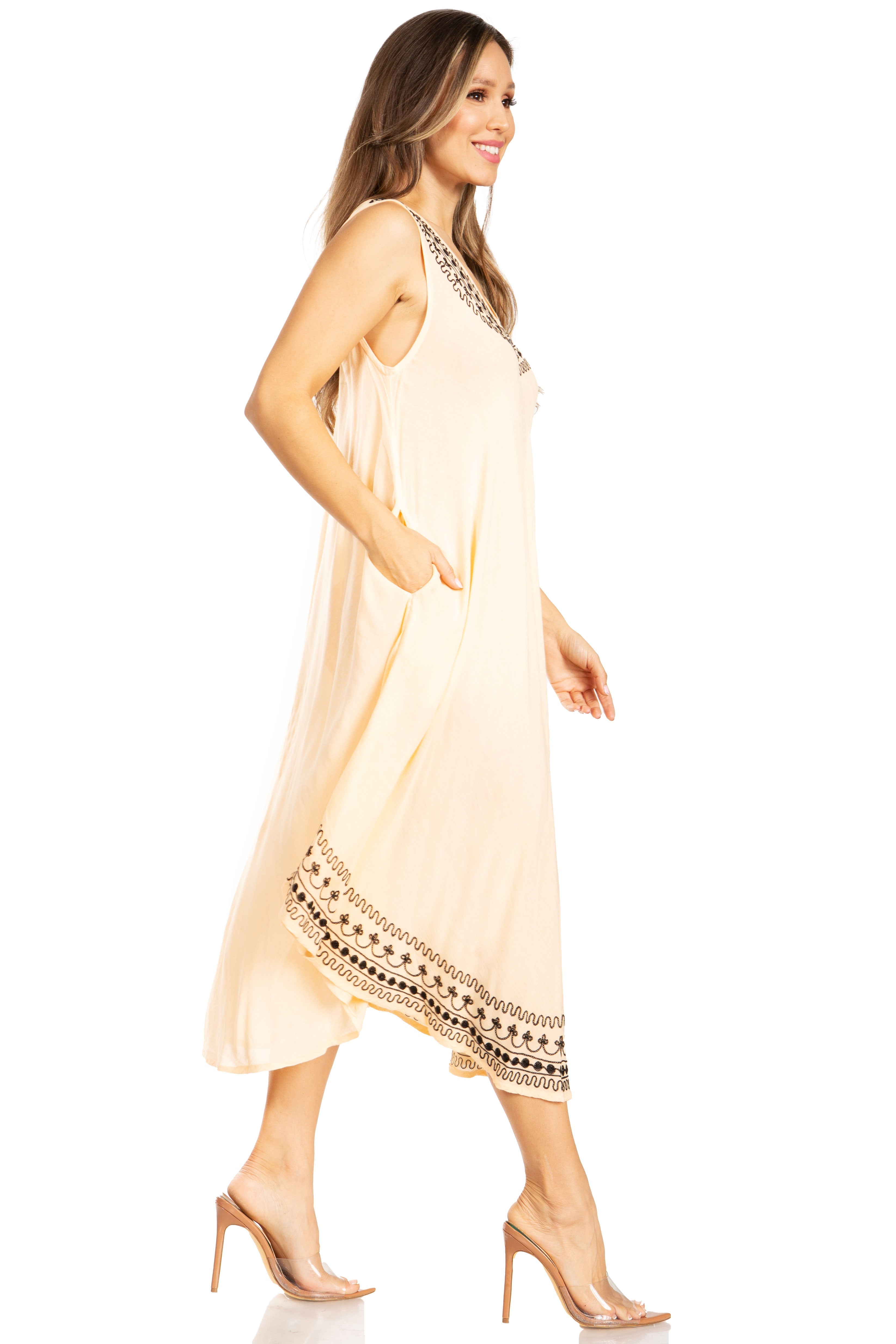 Woman wearing a beige dress with black lace details on a white background