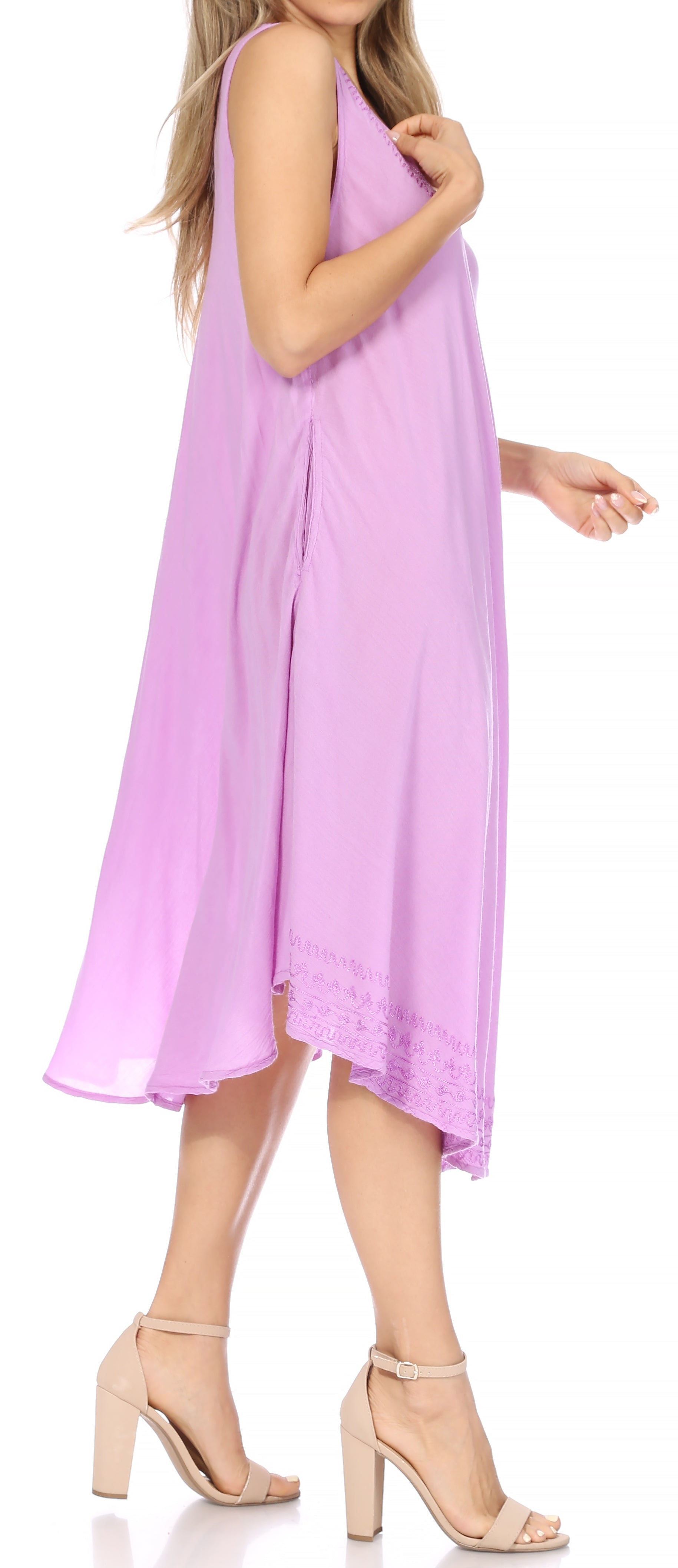 Woman wearing a light purple sleeveless dress on a white background