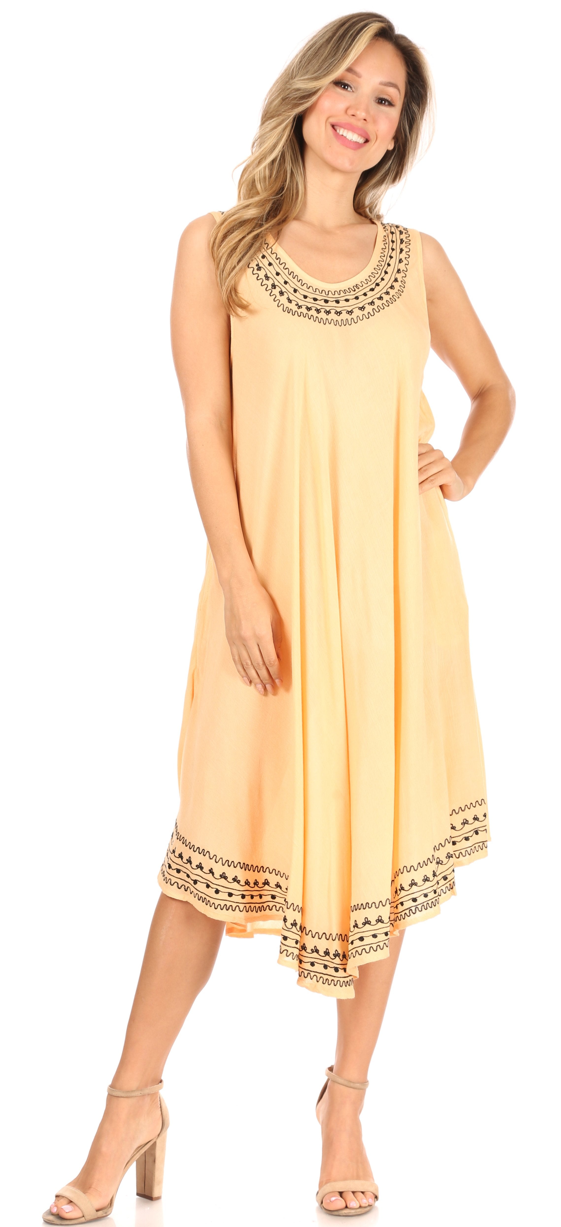 Woman wearing a yellow dress with black patterns on a white background